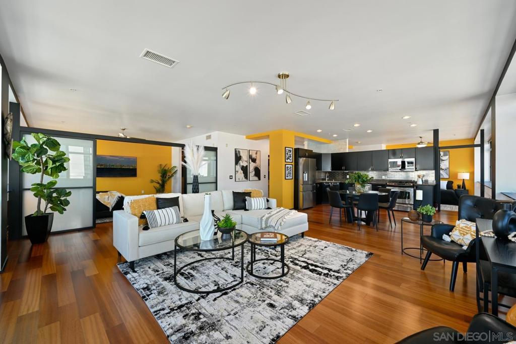 The BEST floor plan in Solara Lofts! This stunning NW corner loft residence is perched on the 6th floor of Cortez Hill, showcasing sweeping walls of glass and fantastic views of Balboa Park and the Bay. A true rarity, this light-filled home features a split-bedroom layout for ultimate privacy, wood flooring throughout, and an updated kitchen with modern appliances. Enjoy indoor-outdoor living from your private wrap-around balcony. Practicality meets convenience with ample storage, including two dedicated storage units, plus two side-by-side parking spaces. The building also offers 8 guest parking spaces for visitors. Club Solara amenities include a pool table room, foosball, gym, saunas, and a racquetball court, creating the perfect balance of leisure and wellness. Best of all, you can meet your neighbors over a glass of wine or join a cooking class at Quigley Fine Wines, conveniently located on the building’s ground floor. With abundant natural light, a thoughtful floor plan, and a vibrant community setting, this home truly captures the best of urban living in one of San Diego’s most desirable neighborhoods.