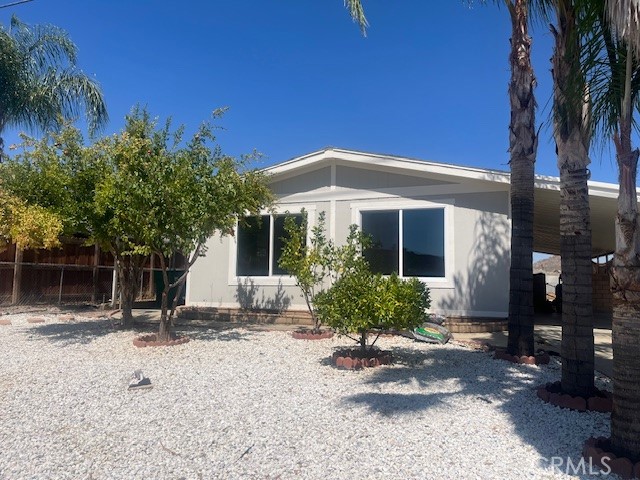 Country living yet close to town! Newly renovated and ready for you to enjoy! All age neighborhood with low taxes and no HOA! Brand new roof and windows! New exterior & interior paint, carpet, laminate flooring! Beautiful kitchen featuring quartz counters, solid wood cabinetry & stainless appliances. Bathrooms newly refreshed with sinks & quartz counter tops. Nicely sized dining room & living room with abundant windows capturing serene views! A multitude of fruit trees enhance this property, along with a storage shed, large backyard & carport. Sits on a 433 permanent foundation! Move in ready, don't wait!