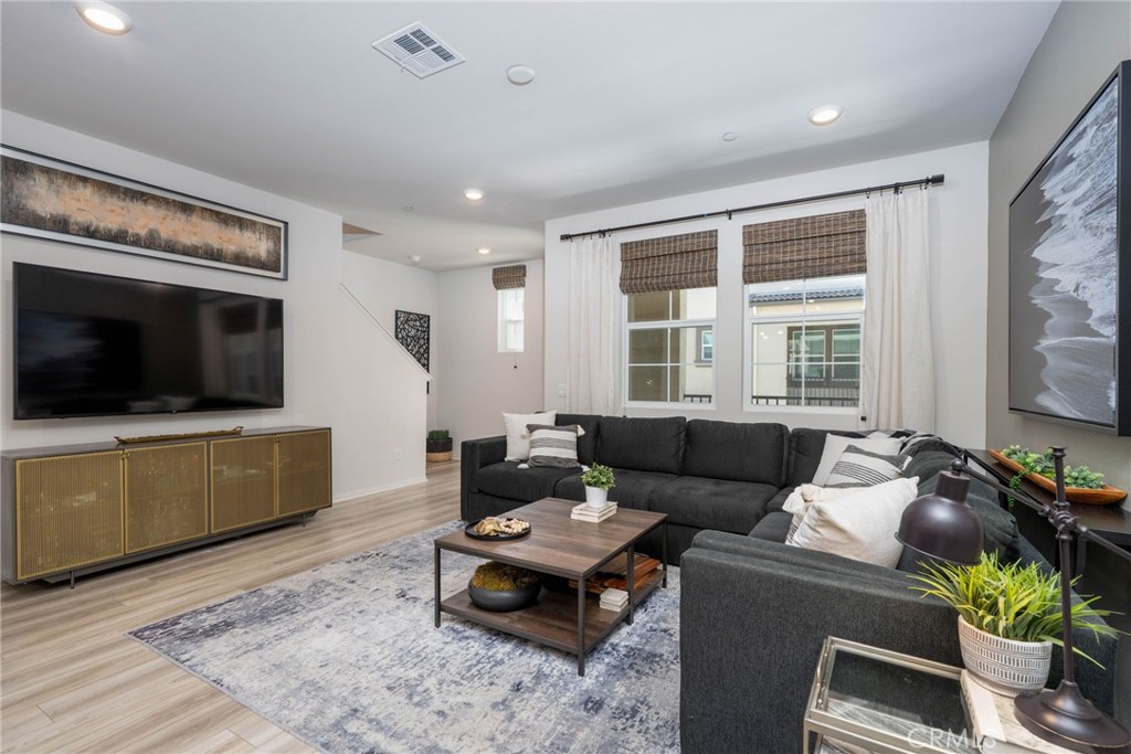 Pride of ownership shines in this stunning newly built townhome located in the highly desirable Heirloom Farms community of Temecula. Thoughtfully designed with comfort and style in mind, this modern home features quality upgrades throughout, including paid-off solar, luxury vinyl plank flooring, and stylish finishes. The open-concept layout is filled with natural light and offers a seamless connection between the gourmet kitchen, dining area, and spacious living room—perfect for both daily living and entertaining. Private balconies provide relaxing outdoor space, while the third bedroom has been transformed into a cozy home theater ideal for movie nights or gaming. Residents enjoy access to top-notch community amenities including a sparkling pool, spa, BBQ areas, and playgrounds. Located just minutes from top-rated schools, shopping, wineries, and dining, this beautifully upgraded, low-maintenance home offers the ideal blend of comfort, convenience, and modern living in one of Temecula’s most vibrant neighborhoods.