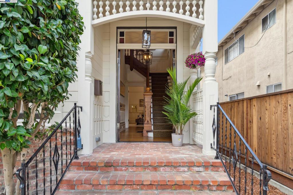 This unique Alameda property features two residences on one lot: a preserved 1895 Victorian and a mid-century duplex. The 2400-sf Victorian home captivates with original architectural details like a hand-carved staircase, soaring ceilings, ornate moldings, and decorative fireplaces. Its interior includes a light-filled living/dining area, an updated kitchen, and a media room, while the upstairs offers four bedrooms, two bathrooms, and a porch. Recent upgrades include a newly painted exterior, updated lighting, a Tesla charger, and updated electrical. Adjacent is a separate duplex with two updated 2-bed, 1-bath units. Both feature modern kitchens, new windows, in-unit laundry, and private storage. The duplex provides a substantial rental income of $5,400 monthly. Located in vibrant, historic Alameda, the property is close to top-tier schools, diverse shops, restaurants, Crown Memorial Beach, and offers easy transit to San Francisco via bus and ferry. This exceptional offering provides a rare blend of historical charm and a lucrative income stream, making it a unique investment.