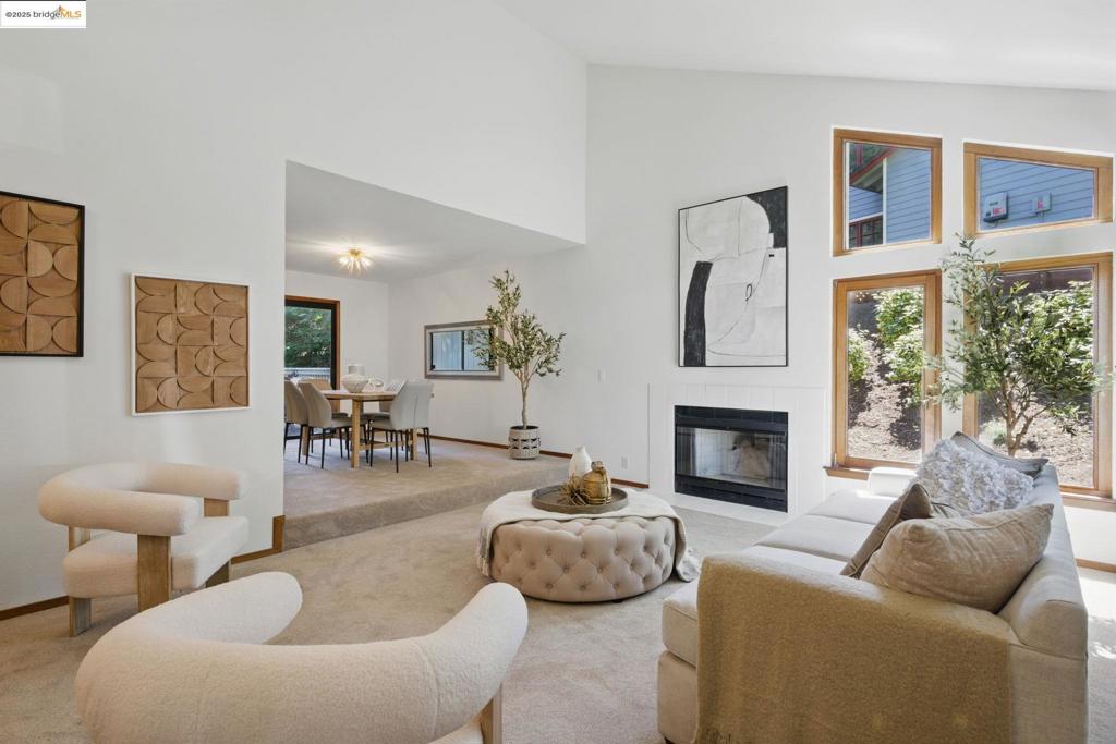 Light and spacious townhome with an open floor plan, this 1990 duet boasts stunning European double-pane windows, 3 bedrooms, 2.5 baths, 3 decks, 2 fireplaces, and a 2-car garage. Just a few blocks from the shops and restaurants of Rheem Valley, it is located in the highly-rated Moraga School District, less than a mile from both Rheem Elementary and Campolindo High School. The primary bedroom suite is generous, featuring deep walk-in closets, a soaking tub, double vanity, beautiful tiled shower, and vaulted ceilings. The kitchen is a chef's dream with a Jenn-Air cooktop, under-counter vent/fan, window box above the sink and ample counter space and cabinetry. You'll love the huge great room with a gas fireplace, perfect for gatherings, and access to a large deck ideal for entertaining. The sunken living room has a vaulted ceiling, another fireplace, and distinctive double-pane wooden windows. Plus, the dining room includes a wet bar and opens to an updated deck for al fresco dining.