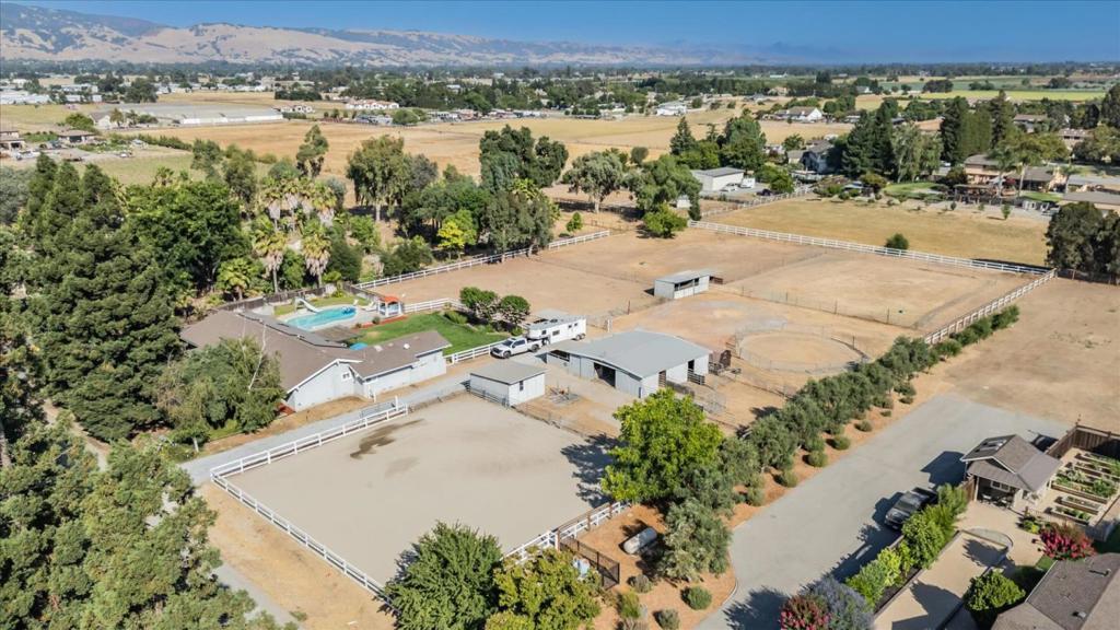 This dream horse property offers a modern & tranquil living experience on @ 2.5 ac. The property features 4 BR & 2BA, providing ample space for various living arrangements. With approximately. 2,500 square feet of living area, this home offers a versatile floorplan Stepping inside, you'll find a freshly painted interior & new SPC flooring throughout most of the home, creating a warm and inviting atmosphere. The updated kitchen and bathrooms blend function and style. The home's energy-efficient features are noteworthy, including an owned solar 12KW system, two power walls for complete energy independence, and a 220V outlet for electric vehicle charging. The attic fan, vapor barrier, and buried Starlink line from the backyard to the home office further contribute to the property's sustainability and connectivity. The smart locks on all doors and the smart vents by Flair to control the AC and heating in each room add to the home's technological advancements. A five-stall horse barn plus tack and hay storage, along with an outdoor wash station. There is also a 75x75ft riding arena, round pen, and multiple paddocks. The gate system at the arena has a flex-sized gate width, for easy access and maneuvering of trailers. A fenced Heated Pool & Spa, for more fun with friends and family!