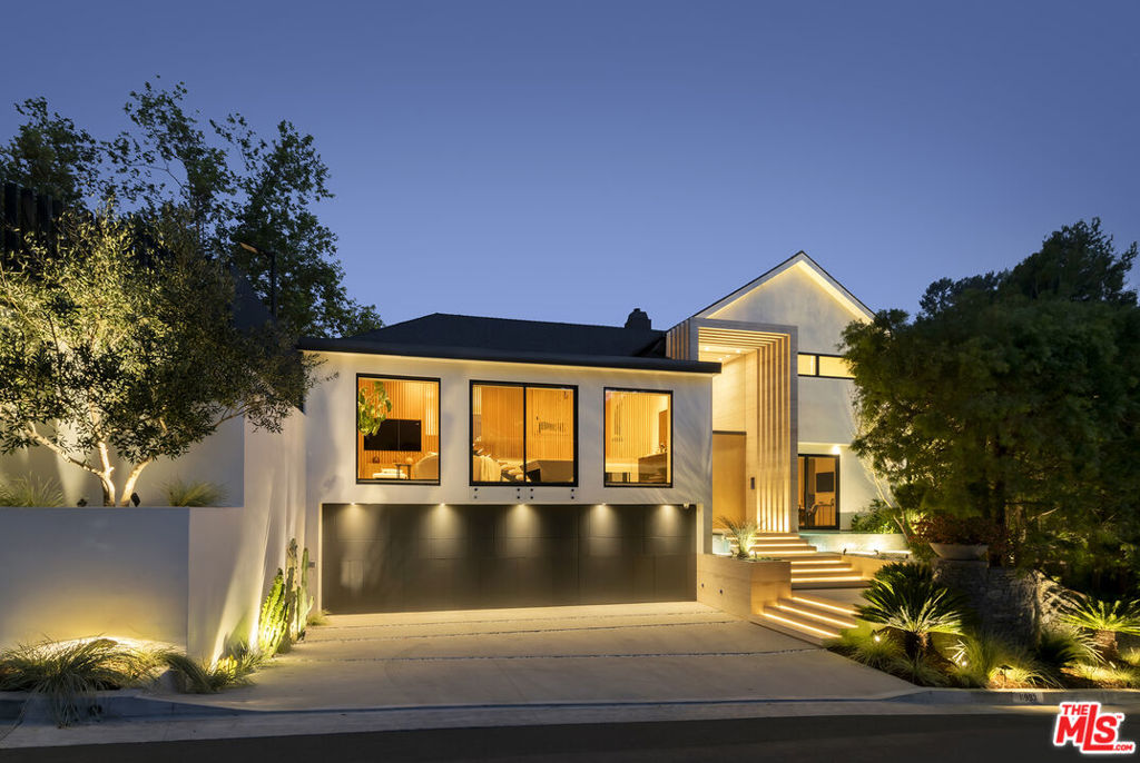 An astonishing architectural paragon is newly complete, designed by Zahra Khajooei and meticulously crafted with the choicest materials while masterfully employing design principles to form a perfect haven of ultimate comfort, recreation, privacy, and luxury with Getty Center views. Certainly one of the most important pieces to come to market in 2024, this smart-home, tennis court residence is set on a private, non-through street and delivers a modern lifestyle of experiential discovery and endless inspiration. An impressive repetition of stone leads to a double-height foyer dressed in travertine as a series of wood panels converge to simultaneously draw the eye upward and forward into the public entertaining spaces. Picture windows and motorized Fleetwood doors reveal bursts of lush greenery and the surrounding natural paradise. The open-concept plan leads from formal living room to dining, each characterized by the adjacent floating staircase, itself a centerpiece on display. A sleek Poliform kitchen is equipped with rich marble countertops and island as well as a butler's pantry and state-of-the-art chef-grade appliances including Gaggenau, Miele, and Sub-Zero. Overlooking these spaces is a thoughtfully designed family room that doubles as a viewing lounge for afternoon tennis matches and includes a billiards/gaming area and wet bar. The primary wing is complete with a stone fireplace, private balcony, and spa-like bathroom with floating dual-sink vanity, makeup desk, pedestal soaking tub, and double-size rainwater/steam shower with ledge, all amidst views of untouched California hilltops in the distance. There are also dual changing wardrobes. Outside, relish the infinity-edge pool and spa with baja shelf, enjoy the outdoor kitchen and dine al-fresco, and converse with friends and family in the conversation pit and lounge areas. A motorized gate partition retracts to reveal the full-size tennis court with sports turf, putting green, basketball hoop, and adjustable net for pickleball, volleyball, or badminton. Other amenities and modern conveniences include Juliet balconies in the secondary bedrooms, motorized blackout shades throughout, dog wash, two laundry rooms, and recessed storm drains. Located in one of the most desirable sections of Brentwood, this home is just moments to the area's fine dining, shopping, hiking trails, freeways, and important cultural landmarks plus all the Westside offers. Also available for lease.