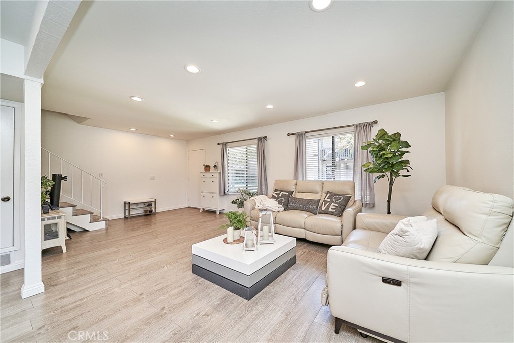 Welcome to this stunning home in the coveted Tiburon community of Cerritos! This is an incredible opportunity to own the largest floor plan in the Tiburon Complex. Offering four spacious bedrooms and 2.5 bathrooms, this end-unit home provides ample space for comfort and convenience. As you step inside, you'll be greeted by freshly updated features, including modern laminate and vinyl flooring, new paint, and scraped ceilings throughout. The bright and airy living room, bathed in natural light and enhanced by recessed lighting, creates an ideal space for family gatherings and entertaining. A updated half-bathroom is conveniently located downstairs. The chef-inspired kitchen has been thoughtfully remodeled with crisp white shaker cabinets and sleek quartz countertops. Adjacent to the kitchen with a large double-pane sliding door, a cozy courtyard invites you to enjoy outdoor living. Upstairs, you'll see three generously sized bedrooms and one private master suite with a walk-in closet and an en-suite bathroom. The hallway bathroom is centrally located offering easy access to the additional bedrooms. Located within the ABC Unified School District and easy access freeway. Residents of Tiburon also enjoy a wealth of HOA amenities, including a clubhouse and pool. Don't miss out on this exceptional opportunity!