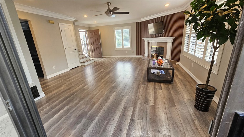 Amazing Upgraded 3-bedroom,2-bathroom, 2-story condo with a 2-car garage. Pull into your gated community and park in your 2-car garage with extra outside parking spaces, that makes you feel very safe. Once inside, you're welcomed by a beautiful space with warm designer colors, stylish walls, wood floors, scraped ceilings, recessed lights, crown molding, custom shutters and a fireplace. This home has been beautifully remodeled, with a renewed kitchen. The kitchen is beautiful with fresh paint, newer trendy knobs and a newer farm stainless steel sink. Motorized curtain in the living room. There are 2 bedrooms on the first level and a beautiful, remodeled, full bath. There are 2 cozy balconies with access from the living room and access from the master bedroom, that you can watch Disney fireworks from. Central A/C & ceiling fans in every room. Head upstairs to the HUGE, primary suite where you'll find 3 closets with another beautiful, remodeled bathroom and a private balcony. This home is an end unit with a staircase separating the neighbor. It is move-in ready. It's situated away from the noisy street and is quiet and private. It's walking distance to downtown Garden Grove where there are restaurants and shopping including a supermarket, Costco, Home Depot, etc. Located at the city center, the library, main police station and City Hall are nearby. This home has a light and bright vibe. You'll love calling this place, "home". Water and trash are included in the HOA fee.