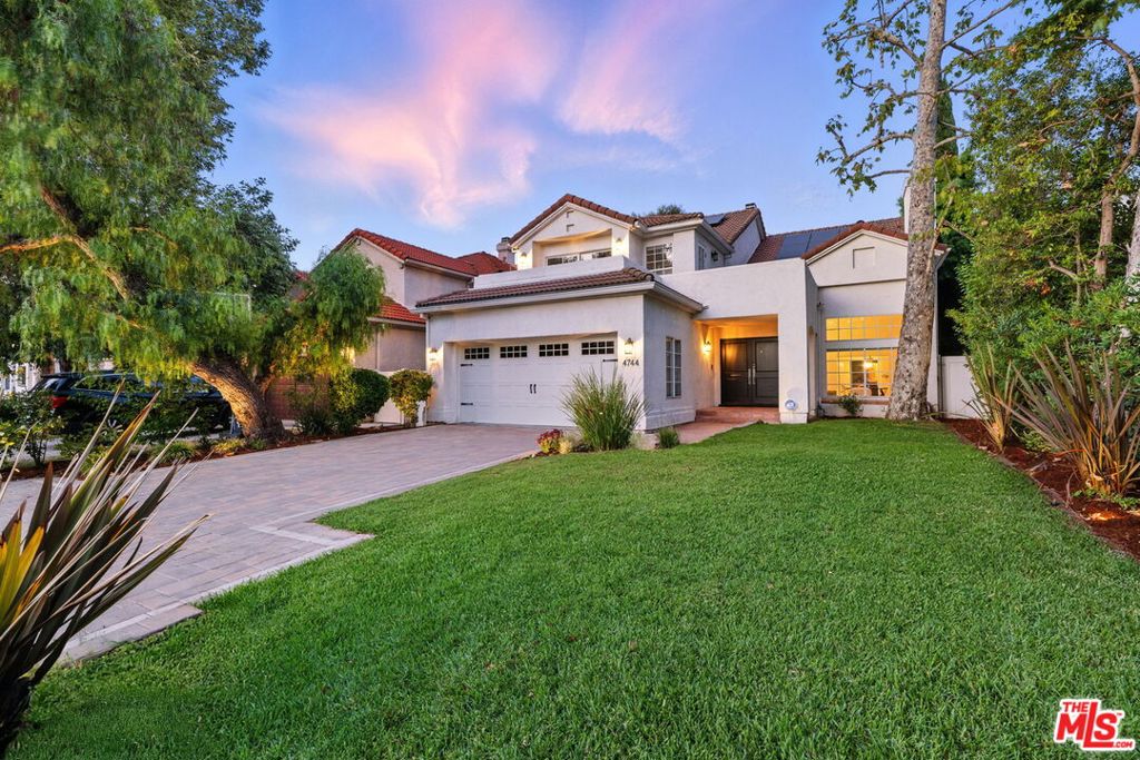 Welcome to this stunning 4-bedroom, 5-bathroom home on a lovely tree-lined street in the heart of Sherman Oaks spanning an impressive 3,499 square feet of thoughtfully designed living space. Step into the bright, oversized living room with soaring ceilings, a marble fireplace, and a large picture window overlooking the lush front yard. The chef's kitchen features top-of-the-line stainless steel appliances, abundant cabinet space, Carrara marble island and counters, subway tile backsplash, and a breakfast area. The kitchen flows seamlessly into a spacious family room with another fireplace, abundant natural light, and sliding glass doors that open to a beautifully landscaped, private backyard oasis. Outside, enjoy the sparkling pool and spa and a grassy turf area perfect for relaxing or entertaining. The first level also includes a versatile pool house/flex space with a wall of French doors, vaulted wood-beamed ceilings, brick fireplace, and a convenient half bath. Upstairs, the expansive primary suite offers high ceilings, a private balcony, sitting area, dual walk-in closets, and a luxurious spa-like bathroom with a soaking tub and separate shower. Additional highlights include rich dark-stained hardwood floors throughout, a formal dining room, spacious guest bedrooms, Carrara marble bathrooms, a laundry room, attached two-car garage, and extra driveway parking. Situated in an unbeatable Sherman Oaks location, just moments away from Ventura Blvd's vibrant dining, shopping, and entertainment options, don't miss the chance to call this stunning property home and experience all that the area has to offer.