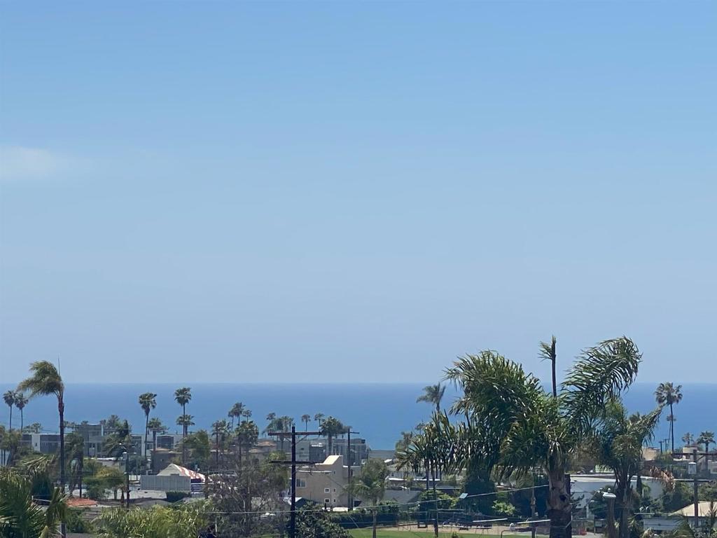 Absolutely incredible Oceanside Propertunity West of I-5 with 3 Ocean-View decks! This single-family home has a unique tri-level design, one of only three on this street. The main house lives like a nice 2-story home featuring 3 bedrooms & 3 baths, including one of each on main level & two ensuite on the uppermost level. The bottom level of the home has its own separate entrance & is a 1-bedroom studio with kitchenette & bathroom that is ideal for use as an AirBNB, long-term rental, guest suite, college student or in-law living. Recent updates include brand new fresh paint inside that feels wonderful to be in, brand new plank flooring, brand new baseboards, & new trim paint. The detached garage with alley entry is connected to the home with a desirable ocean-view Trex-type deck. Your guests will park on Grant Street & immediately be enchanted coming through the new gate color matched to the newly painted front door. Fresh sod, flowers, & mature hedges envelop your beautiful yard with privacy from the street & neighbors. Main level has an open kitchen with a clear line of sight through living room to the ocean-view balcony which adds to the functionality & entertaining potential of this property. Your primary bedroom offers another ocean-view balcony that you will love waking up to & seeing the big blue Pacific Ocean from. Section 1 Termite Clearance is already done for you! Close to everything booming Oceanside has to offer from the hottest restaurants & breweries & great surf spots plus convenient to freeways 5, 76, 78 & Camp Pendleton, too! Don't let this Hot Propertunity pass you by!