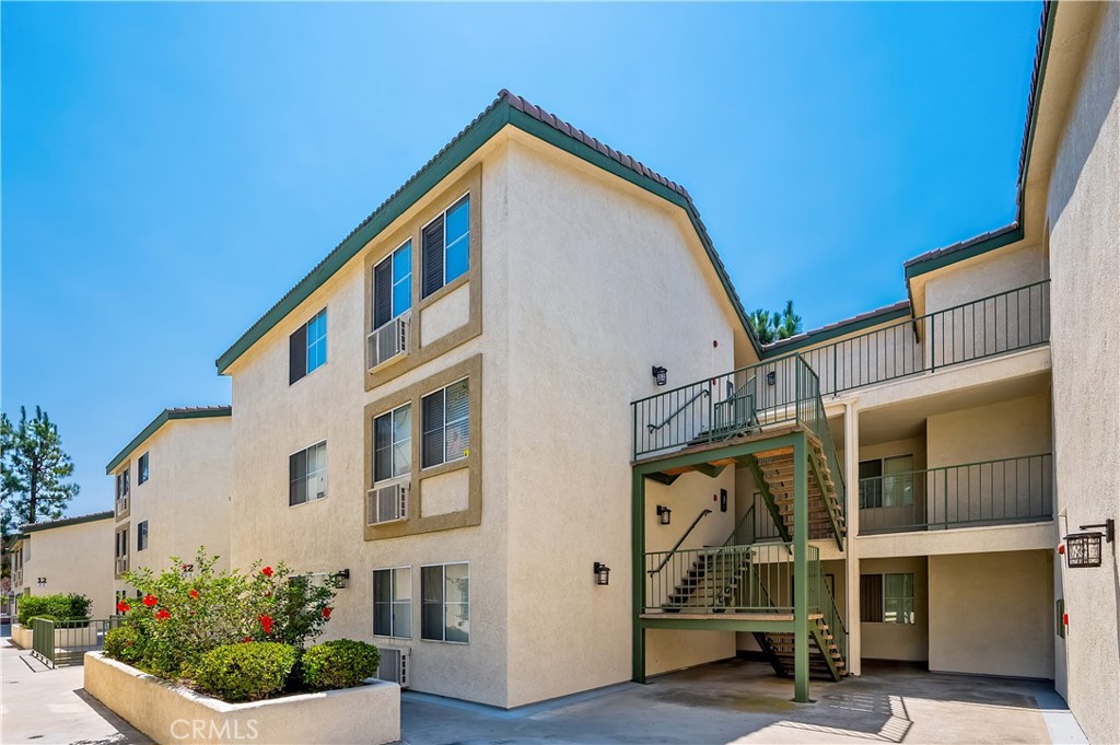 Welcome to this move-in ready 2-bedroom, 1-bath condo in the heart of Paramount! This 858 sq. ft. home features vaulted ceilings and an open, airy layout that seamlessly flows from the living area to the dining space and kitchen. The kitchen offers bar-top seating, perfect for casual meals or entertaining. Both bedrooms include spacious walk-in closets. Additional highlights include updated tile flooring, a newer washer and dryer, and a newer dishwasher for convenience. One of the home’s hidden gems? A huge attic with enough space to stand and walk around—perfect for storage or potential to convert into an open loft. Enjoy resort-style amenities in this gated community, including a pool, spa, clubhouse, BBQ area, and HOA-covered water and trash. The subterranean parking garage includes 2 assigned parking spaces plus additional storage. Close to schools, parks, shopping, coffee shops, and restaurants, with easy access to the 91, 710, 105, and 605 freeways—this home offers comfort, convenience, and a prime location! Schedule your private tour today.
