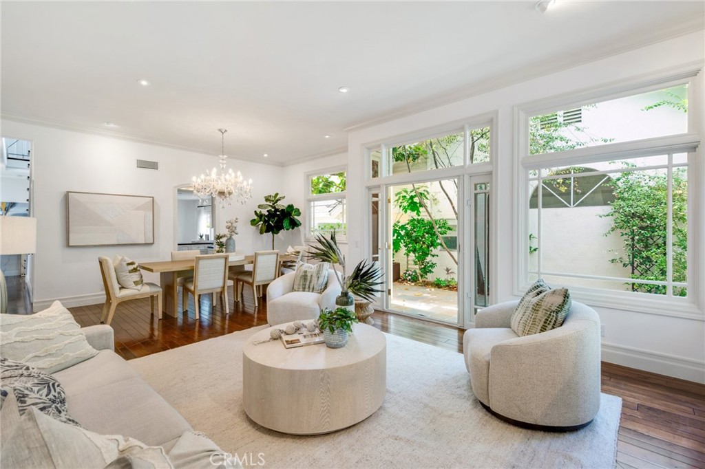 2541 Point Del Mar is one of the rare ones—a thoughtfully reimagined Cape Cod-style residence that defines refined coastal living in Corona del Mar. Spanning approximately 3,180 square feet on a 4,830-square-foot lot, this four-bedroom, five-bathroom home pairs timeless character with modern functionality in a location just moments from the iconic Flower Streets. Behind a gated garden entry, a peaceful courtyard with a fountain welcomes you into curated interiors by Concept Studios—where white oak cabinetry, Waterworks fixtures, custom millwork, and effortless indoor-outdoor flow create a truly elevated everyday experience. The main level features an en suite guest bedroom, as well as a flexible bonus room that works beautifully as a home office, library, or additional guest space. Upstairs, the serene primary suite is a private retreat, complete with spa-like finishes and abundant storage. A spacious secondary primary suite and another en suite bedroom—each with walk-in closets—complete the upper level. The backyard is a lush extension of the home, framed by mature olive and citrus trees and centered around a covered loggia with built-in heaters and media. Multiple seating and dining areas make this an ideal setting for both intimate moments and effortless entertaining. Crowning it all is the only rooftop deck in the neighborhood—an expansive, sun-soaked escape with views of Catalina Island and the Pacific, ideal for golden-hour gatherings or peaceful mornings above the Village. Located just a short stroll from local boutiques, coastal dining, and the upscale offerings of Fashion Island, 2541 Point Del Mar captures the very best of life in CDM.