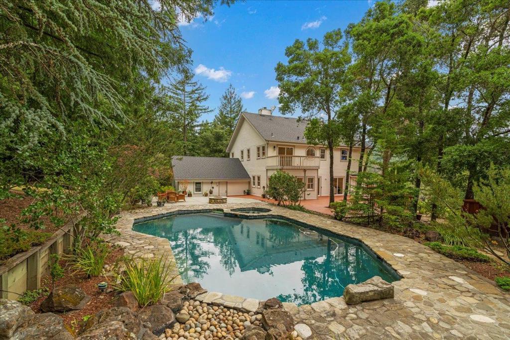 Looking for a fully remodeled mountain home with long range views, privacy and quiet yet just minutes to town? Or highly usable land perfect for a secondary unit or ADU? Then look no further. Nestled just 20 minutes from downtown Los Gatos and equally close to the beaches of Santa Cruz, this fully remodeled home combines refined elegance with modern mountain living. Every detail has been thoughtfully designed, from the luxurious primary suite to the expansive chefs kitchen, feat. quartzite island countertops, a built-in gas cooktop, double wall ovens, and abundant custom cabinetry. The open floor plan feat. soaring ceilings, hardwood and tile flooring throughout, and walls of windows that fill the home with natural light. Nearly every room offers breathtaking views and seamless access to outdoor living...whether its the wraparound front porch, the expansive rear deck, or the sparkling black-bottom pool and spa. With 3,014 sq. ft. of living space on approximately 7 acres, the property provides exceptional versatility and privacy. A two-car garage, pool, and jetted spa complete the amenities, while the land offers opportunities for a secondary dwelling unit, gardens, or equestrian use. Located in the desirable Loma Prieta School District and served by acclaimed Los Gatos High.