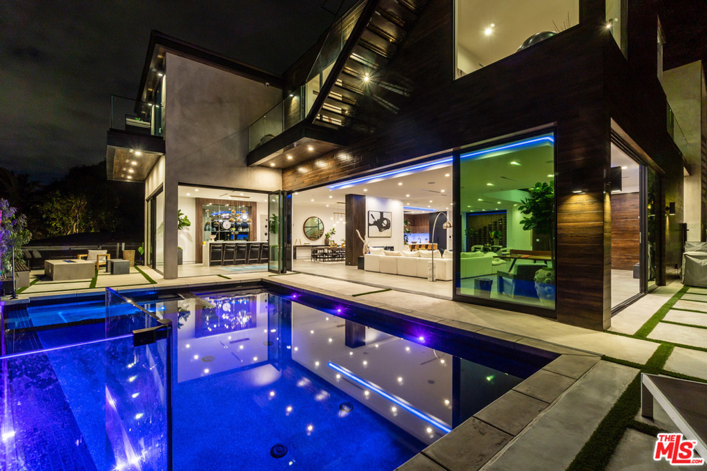 Astounding New Price. Accepting Back Up Offers. NEW CONSTRUCTION. Unique opportunity to own this Bespoke Modern Tropical in prestigious, Bel Air. The 130ft driveway immerses you into this lush OASIS tucked high & behind the road. The indoor/outdoor flow expands out to the infinity edge heated pool & spa. Entertain with your Roof Top Deck, 6-Seat Theater, Bar, 150 btl wine rack, 2 firepits, BBQ, Meditation deck area & Outdoor bath to truly be ONE witn nature on this huge lot. The Kitchen centers a massive 15' Italian Leather Marble island with Wolf appliances including Espresso machine, Double oven, Steam oven, Recessed hood, Sub-Zero fridge & 3 wine fridges. The Master stuns with the transparent fireplace flowing to the stone tub & rain shower with body sprays & steam shower. CUSTOM White Oak Cabinets & Doors, Closets, Bathrooms with concrete & stone sinks, Terrazzo stone tubs, Smart-Home with Security, Sonos sound & Lighting.