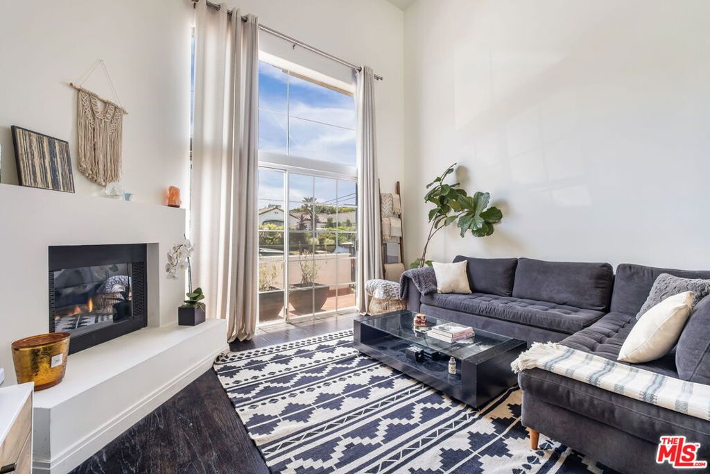 Now available for lease, this immaculate tri-level townhome is ideally located just one block north of Melrose Avenue on a quiet residential street. Featuring 3 spacious bedrooms, 3 en-suite bathrooms, and a guest powder room on the main level, the property also boasts a private rooftop deck with panoramic city views, perfect for relaxing or entertaining. The main level showcases an updated kitchen with gas appliances, hardwood floors, a formal dining area, and a dramatic two-story living room complete with a balcony, wet bar, and fireplace. Each bedroom includes its own en-suite bath, offering comfort and privacy throughout. The second level hosts a generously sized bedroom with a walk-in closet, while the third level features the primary suite with double closets, a private balcony, and an additional large bedroom. An in-unit laundry area adds everyday convenience. Additional amenities include central air conditioning and heating, as well as two gated parking spaces with space for storage. Located within walking distance to local parks, shopping, dining, and The Grove, and just minutes from Beverly Hills, the Beverly Center, Sunset Strip, and Hollywood, this move-in-ready townhome offers the best of central LA living.