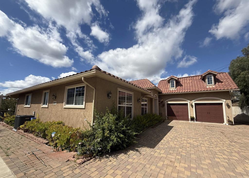 Price reduced! Don't miss this beautiful gated 1.79 acre property in North Vista, with a lovely custom home plus a building with one ADU and other income-producing areas. The main house is a large 2913 sq ft custom single story home, which sits at the top of a hill with panoramic country views off the back. Home has 3 bedrooms including a spacious primary suite and 2.5 bathrooms, all on one level, and a large 3+ car garage. Imported stone floors flow through the home, with gorgeous stonework in the custom kitchen and bathrooms. Large common room has a beautiful fireplace, vaulted ceilings and offers lovely views. Fruit and macadamia nut trees dot the property, which has 2 gated entry points off East Vista Way. Two gravel parking areas and a 10' x 20' storage shed sit at the entry points to the property. At the bottom of the hill, just inside the main gate, is a 780 sq ft ADU within a larger 4000 sq ft building. The ADU has one bedroom, and one bathroom plus a bonus room. Main home is currently rented for $4300 and ADU is rented for $2000 (information per seller). Remainder of 4000 sq ft building is permitted as 'rec room', 'garage' and 'tool room'. Many opportunities for additional income renting these spaces as well, for a variety of uses. Parts are already income-producing. You must see the property to appreciate all the possibilities, from car and RV storage to agricultural uses, and multi-generational living.