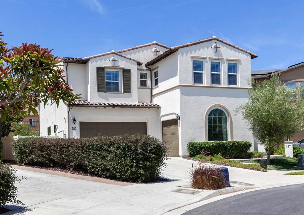 Tucked away at the top of a private cul-de-sac, this 2018 Spanish-inspired home in San Marcos offers owned solar, refined upgrades, and seamless indoor-outdoor living. The open floor plan centers on a gourmet kitchen with granite island and bar seating, custom backsplash, stainless appliances including double ovens, Bosch dishwasher, a counter-depth refrigerator, and walk-in pantry, flowing into expansive living areas with crown molding and custom window coverings. A first-floor bedroom and full bath provide ideal space for guests or multigenerational living. Upstairs, the primary suite includes two walk-in closets and a spa bath with soaking tub, dual vanities, and large shower, while an additional ensuite bedroom has its own walk-in closet and remodeled bath. The builder’s loft option has been enclosed as a true bedroom with closet, and a spacious laundry room adds convenience. Outdoor living features a California Room with fireplace and TV, dining patio, fountain, freestanding fireplace lounge, and gated dog run, framed by mature olive trees and low-water landscaping. * * * Planned with efficiency and versatility, this home features owned solar with 24 panels on NEM2 metering, a 220V outlet in the garage for car charging, zoned HVAC, a whole house fan, and a tankless water heater. The single-car garage was professionally converted to a wellness room with an arched window—perfect for yoga, a den, or library—and can be restored if desired. Interior upgrades include crown molding, recessed lighting, shiplap accents, and custom window coverings that add polish throughout. A spacious upstairs laundry room provides convenience, while the finished main garage includes storage solutions for everyday function. The grounds are enhanced by mature olive trees, turf, low-water landscaping, and accent lighting, with thoughtful hardscape details including French drains and rain gutters. A Ring doorbell adds smart-home ease. Ideally situated near Twin Oaks Golf Course, Cal State San Marcos, top-rated schools, dining, shopping, and freeway access.