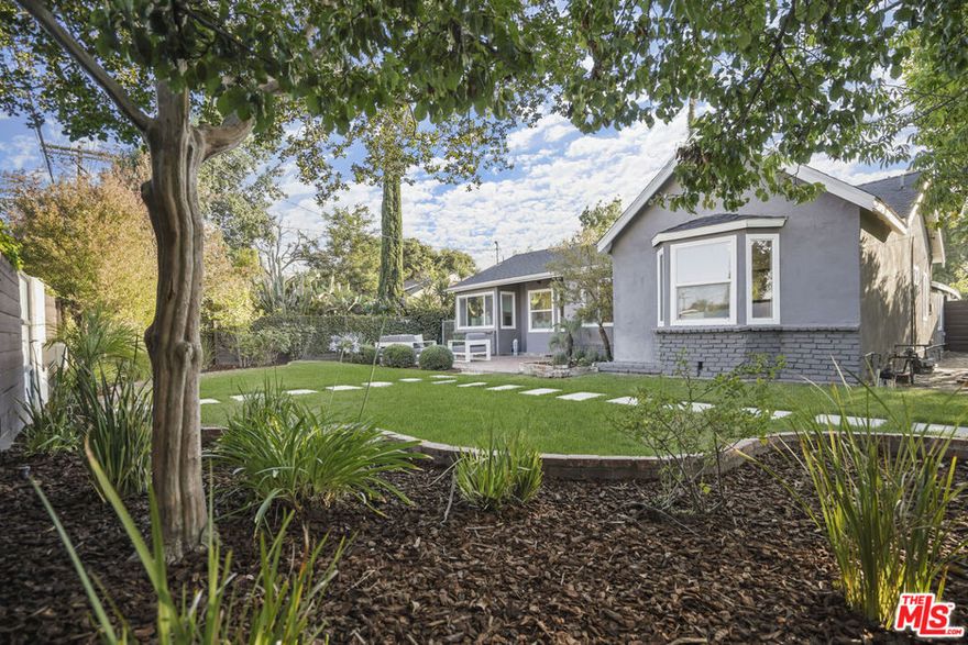 Presenting a beautifully updated and modernized California Traditional sited in the most sought after neighborhood in Valley Village: An idyllic, vibrant tree lined community and wonderful place to call home! With a lush fusion of floral and greenery and fully hedged and gated for privacy and security, the home resides on a sweeping 8,000+ sq.ft. double corner lot across from the award winning Colfax Charter Elementary School (Ranked 9th best charter school in California!).  Remodeled with the design and amenities ideally suited for today's contemporary lifestyle, the home features an appealing open floor plan that provides gracious transition from room to room, suffused in an abundance of natural light from expansive use of windows. Wide plank wood floors grace the living areas. Recessed lighting glows throughout the home. Modernized baths feature fine lighting, fixtures and finishes. The open concept kitchen is optimally designed for the adventurous at home chef and features high end stainless steel appliances, Carrera marble counters and breakfast bar, butler's pantry and adjoining sunlit breakfast room. Becoming one with the great room, it's the perfect gathering place for entertaining with friends and family. French doors bring the outdoors in and give way to a sprawling backyard lawn, deck, patio and pergola perfect for al fresco leisure. Three bedrooms plus a den, with three baths including a lux primary suite round out the comfortable accommodations for family and guests. Centrally located just moments from beloved Valley Village Park, NBC, CBS, Disney, Warner Bros. and Universal Studios, and the art galleries, studios, eateries, and theaters of the famed NoHo Arts District. Welcome!