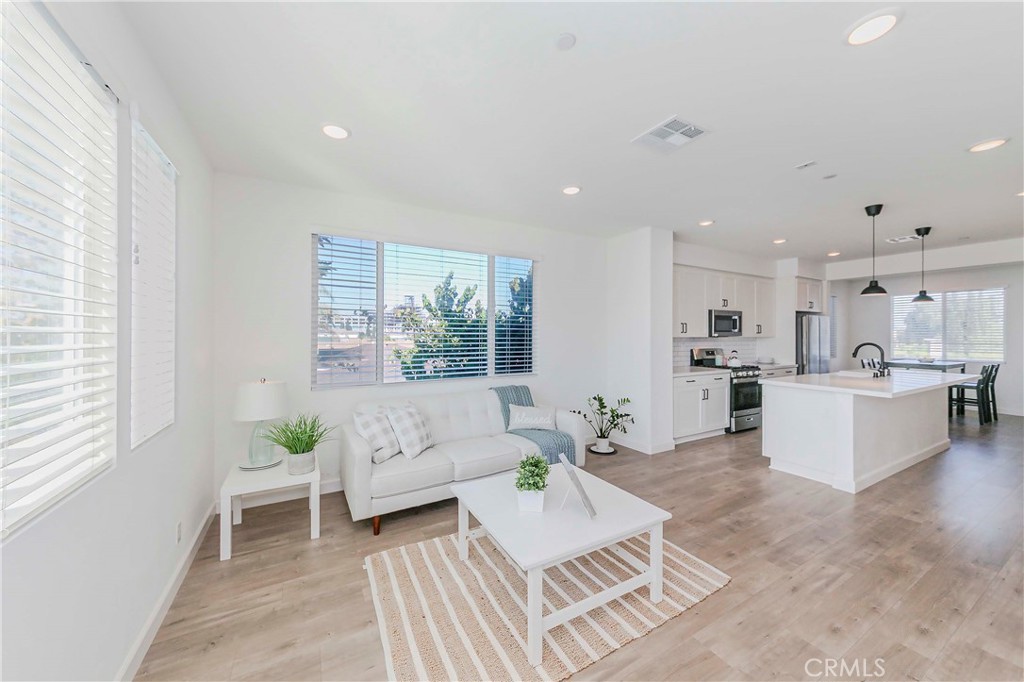 Welcome to this stunning contemporary townhome in the highly sought-after Flora Walk Community!
Built in 2021, this bright end-unit home offers 3 bedrooms and 3.5 bathrooms with a modern, stylish design and meticulous attention to detail throughout. The open-concept living area is filled with natural light and features elegant laminate wood flooring.
The gourmet kitchen boasts a spacious Quartz countertop island and premium stainless steel appliances — perfect for both everyday living and entertaining. A bedroom with a full bathroom is conveniently located on the first floor, ideal for guests or a home office.
Upstairs, the primary suite offers a walk-in closet, dual sinks, and a beautiful shower. The third en-suite bedroom also includes its own private bathroom. The laundry area with stackable units and extra storage is located on the same floor for added convenience.
Additional features include recessed lighting, a tankless water heater, central A/C & heating, a 2-car side-by-side garage with direct access, and an EV charging station.
HOA due $284/month. Community amenities include a fire pit, BBQ area, pet area, gated entrance, and ample guest parking. Convenient location! Close to schools, freeways, shopping, and dining. Don't miss out on this beautiful home!