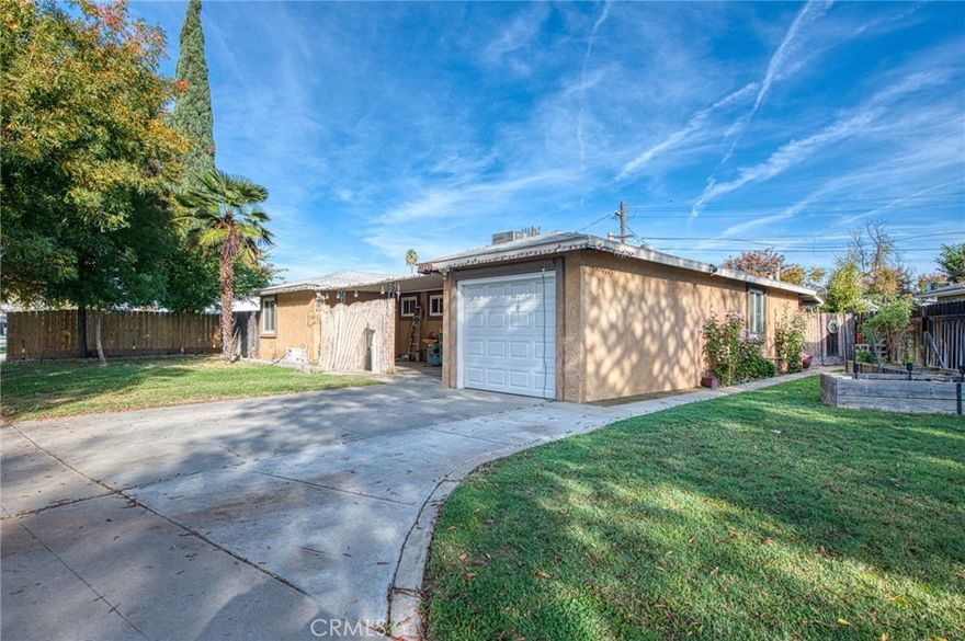 Welcome home! This charming 3-bedroom, 2-bath gem in the heart of Fresno has all the right updates and a location you'll lovejust minutes from Fashion Fair Mall, restaurants, and easy freeway access. Step inside and you'll feel right at home with wood-style floors throughout the living room, hallway, and bedrooms, giving the space a warm and modern touch. The kitchen and bathrooms have been tastefully updated, and with newer windows and HVAC, you can move right in and enjoy comfort and efficiency from day one.

Outside, you'll find a fenced backyard with a covered patio that's perfect for relaxing or entertaining, plus cute garden beds along the side for your favorite flowers or veggies. There's even potential space for a small ADU Whether you're a first-time buyer, downsizing, or looking for an easy investment, this home is a great find in a fantastic central Fresno location!