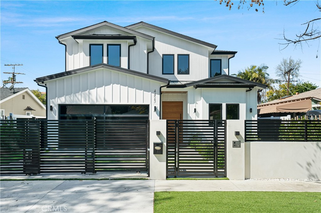 Experience luxury living in this striking 2023-built modern compound, ideally located on one of Studio City's most sought-after streets. Privately gated and thoughtfully designed, this architectural masterpiece offers soaring ceilings, a stunning chef’s kitchen with a custom wine display, and effortless indoor-outdoor flow perfect for entertaining. The resort-style backyard features a sparkling pool and spa, an outdoor kitchen, and a flat grassy area — all framed by lush landscaping for maximum privacy. Upstairs, the expansive primary suite impresses with a spa-like bath and a boutique-style walk-in closet, complemented by four additional bedrooms. A detached ADU with its own entrance and bath provides an ideal setup for guests, a home office, or gym. Additional highlights include solar power, smart home automation, a security system, gated driveway, and a two-car garage. Just moments from Ventura Blvd’s premier dining, shopping, top-rated schools, studios, and hiking trails.