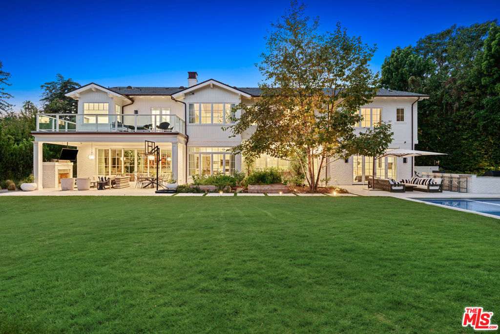 Situated on one of the most coveted streets of Brentwood Park stands this ultra-private bespoke estate. Set on nearly half an acre, this 6 bedroom, 8 bathroom, 13,425 sqft modern traditional home was completed in 2018 with designer finishes at every turn. Boasting some of the highest attention to detail, this is truly a one-of-a-kind estate. The floor plan is impeccable; the formal entry, which is an architectural work of art, opens to the formal living and dining rooms which have extravagant doorways, hardwood flooring, large windows, and custom wood moldings and trim. The large kitchen enjoys imported marble slabs and a center island while overlooking the rear grounds, the breakfast room, and the huge family room which has warm wood flooring, a wet bar, and a fireplace. The lower level encompasses a second family room, large formal bar, walk-in chilled wine room, a gym, guest bedroom and an ultimate movie theater. On the top floor, the Five Star primary suite features a vaulted wood paneled ceiling, spa-like bathroom lined with imported marble slabs with two seperate bathrooms joined by an oversized glass shower, a private patio and two separate walk-in clothes that rival any luxury department store. The park-like grounds are perfect for anyone commanding privacy and space which is completed with a security gate and mature hedge. Host a pool party with all your friends and family. Enjoy cooking in the outdoor kitchen with a built-in grill or lounge under the covered patio and relax as the little ones play soccer on the field. Truly a home for the most discerning buyer.
