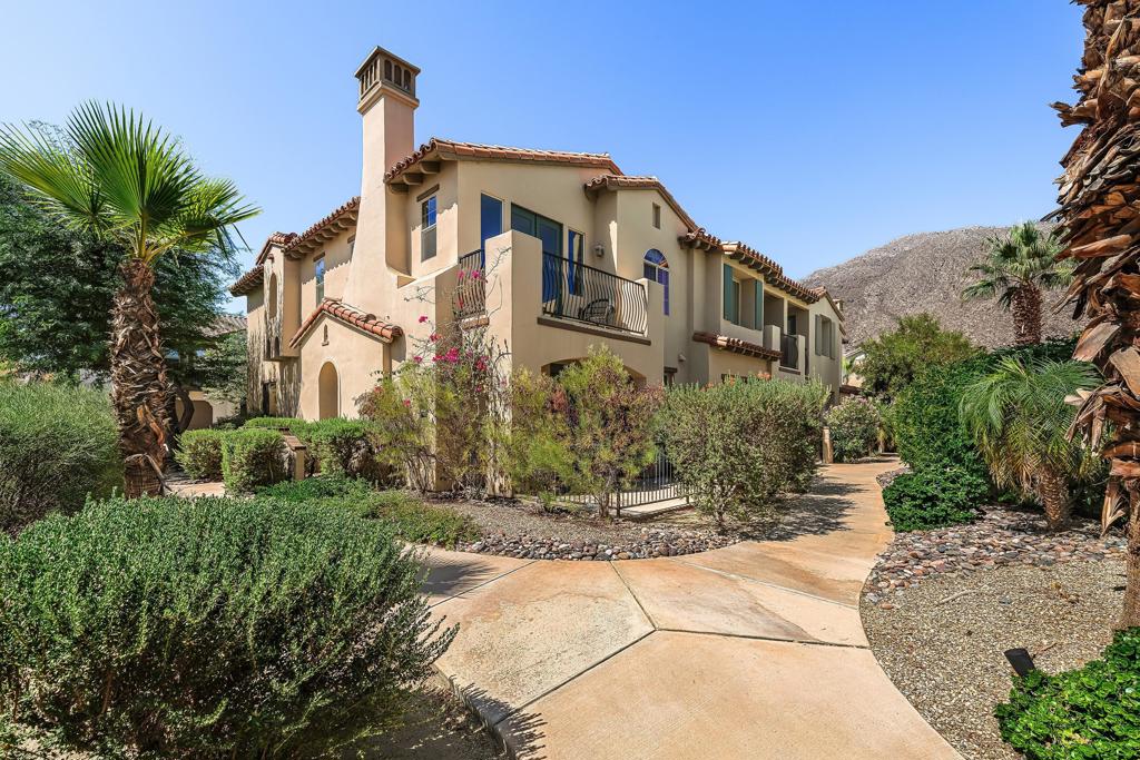 Welcome to Villa Fox Trail, a beautifully transformed property that exudes luxury and sophistication with its high-end finishes and exceptional ambiance. Step inside to find yourself in a remarkable retreat, all while being just a short walk from the lively downtown Palm Springs. This one-of-a-kind villa features an open-concept layout accented by impressive high-beamed ceilings, a charming stone fireplace, and elegant French doors that open to a spacious patio with stunning mountain views. The kitchen is a culinary haven, designed for the most discerning chefs, featuring top-of-the-line appliances and a central island perfect for gathering and creativity. Upstairs, a welcoming loft area offers versatile space for an office or TV lounge. The expansive primary suite boasts a private balcony with views over the pool and mountains, plus an attached flex room that could be another sleeping area or exercise area. The newly redesigned primary bathroom offers a spa-like experience with a double vanity and walk-in shower, complemented by a custom walk-in closet with extensive storage space. An ensuite guest bedroom is situated on the opposite side of the home for complete privacy. Set within the gated boutique community of Village Traditions, residents enjoy a resort-style center pool area, gym, BBQ facilities, and a dog park. Center of downtown is .06-mile walk, and Arenas Rd. is only .04. Restaurants, bars and shopping right at your fingertips!