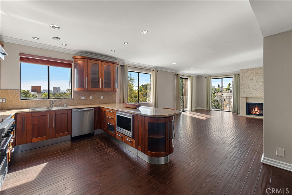 Just the perfect Beverly Hills Top Floor Corner Condo, walking distance from Rodeo Dr. An exceptional offering: 2 bedrooms, 2 full baths, and 1,640 SF of living space, highlighted by a wraparound corner balcony and private in-unit laundry. Views of Downtown from your balcony, kitchen and dining space. More Views of Century City sky rises and palm trees from your West and South facing balcony. Lavish double door entry into the unit where you’ll be covered in light shining through the wall of West facing windows. The most gorgeous morning sunrises over coffee or breakfast in your Viking-equipped kitchen, framed with rich wood cabinetry. With lofty ceilings in every room, this residence stands apart as the crown jewel of the building. Master bedroom has enough space for a California King bed, additional seating space, office desk, and more. Huge walk in closet with built ins and the sizable en-suite bathroom includes a double vanity and a hot tub. The guest bedroom has an advantageous size and a closet with a built in organizer. Second bathroom also features a large soaking tub. Very low HOA for the area under $400/month. Located within the prestigious Beverly Hills School District right in between Beverly Vista Middle School and Horace Mann Elementary, moments from Rodeo Drive, upscale dining, shopping, and renowned art and entertainment venues.