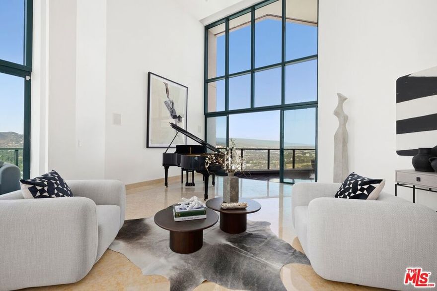 **Rare Penthouse at The Blair House -The Pinnacle of Wilshire Corridor Living** Perched atop the iconic Blair House, one of the most prestigious full-service addresses on the Wilshire Corridor, this rare penthouse offering blends dramatic design, contemporary elegance, and sweeping panoramic views into a truly unforgettable residence. Step into the striking formal entry where a sculptural spiral staircase introduces you to soaring 25-foot ceilings and vast, floor-to-ceiling windows that flood the living space with natural light. From the Griffith Observatory to The Getty and beyond, nearly every room offers unobstructed, picture-perfect views. The expansive living room seamlessly extends to a private balcony an ideal backdrop for indoor-outdoor entertaining. A formal dining room comfortably seats 12+ with inspiring vistas toward the Hollywood Hills and Downtown Los Angeles. A stylish den with built-in wet bar creates an inviting space for intimate evenings or movie nights. The newly renovated chef's kitchen boasts premium appliances, sleek cabinetry, and an adjacent breakfast area offering tranquil morning views. A private en-suite guest room sits quietly on the main floor, providing comfort and separation. Upstairs, access the second level via your own in-unit elevator to discover three spacious bedroom suites and an airy loft lounge or home office, all oriented to capture dramatic skyline scenes. The primary suite is a luxurious retreat with a private sitting area, balcony, and an indulgent, spa-inspired bath. Dual bathrooms offer a sauna, soaking tub, oversized shower, vanity area, and separate walk-in closets. An attached gym or office completes the suite, surrounded by floor-to-ceiling views. Additional highlights include:- Smart home integration with new AV system, high-speed Wi-Fi, security upgrades - Modern designer lighting throughout  - Ample in-unit storage and closet space   Residents of The Blair House enjoy five-star amenities: a resort-style pool and spa, rare tennis court, cutting-edge fitness center, meeting suite, 24-hour valet and concierge, and round-the-clock security, an unmatched lifestyle in one of LA's most desirable high-rise communities.