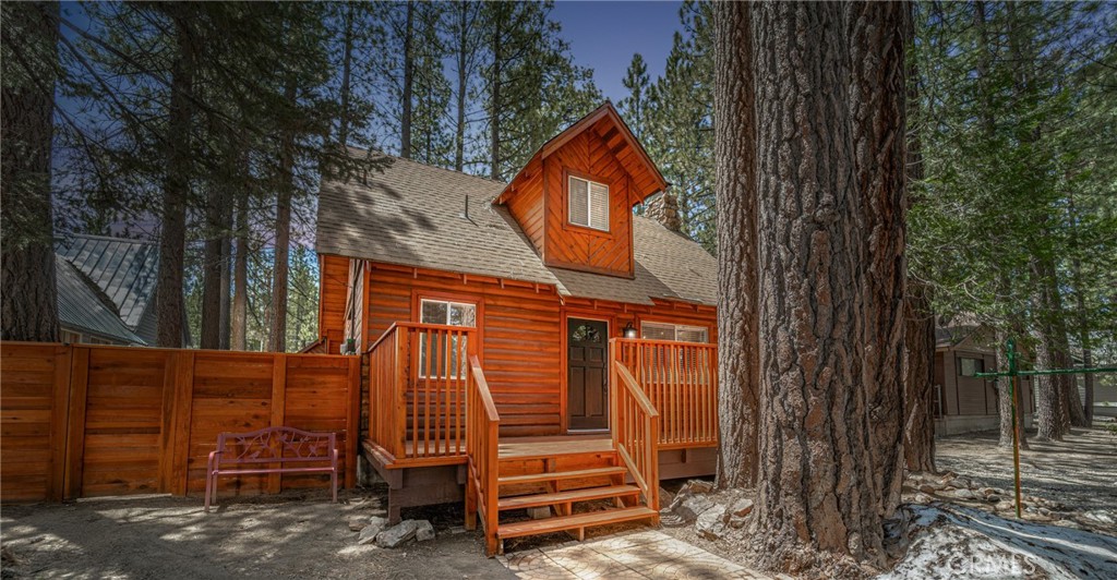 Welcome to a retreat nestled in the beautiful Boulder Bay area of Big Bear Lake. Enjoy a cup of tea or coffee on the newly installed front deck, or head to the back pergola and take in the peaceful privacy of the new, fully fenced yard. This beautiful cabin features an oversized, two-story detached 2-car garage that can be converted into a game room or additional living area, a rare feature in Big Bear Lake. This exceptional property has been renovated and is waiting to become your dream second home or a fabulous short-term rental. It is just 5 minutes to the village, 9 minutes to the ski resort, and within walking distance of the lake.
