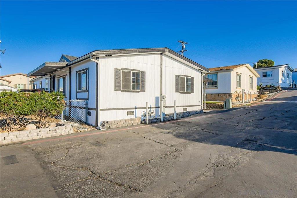 Fully remodeled and move-in ready, this stunning 3-bedroom plus BONUS ROOM, 2-bath home offers nearly 1,500 sq. ft. of upgraded living space in one of Santee’s most desirable all-age mobile home communities. Inside, you'll find vaulted-style ceilings, a large skylight, recessed lighting throughout, and a cozy fireplace in the spacious open-concept living area. Fresh interior and exterior paint and new luxury vinyl plank flooring create a bright, modern feel. The upgraded kitchen is a show stopper with features that include natural granite countertops—including a custom island—stainless steel appliances, sleek cabinetry, modern fixtures, and plenty of storage. The oversized primary suite offers a custom walk-in shower, dual-sink vanities, and elegant finishes. A large bonus room provides flexible space for a home office, playroom, or whatever your preference. Upgrades include a new HVAC system, new roof, dual-pane windows, updated plumbing, tankless water heater, and two outdoor storage sheds. Outside, enjoy a low-maintenance backyard and a spacious side yard ideal for gardening, dining, or simply unwinding, with guest parking nearby. Set in a rent-controlled, well-maintained community with a pool and clubhouse, this home is walking distance to parks, trails, shopping, dining, and schools. Stylish, spacious, and fully updated—this home truly has it all!