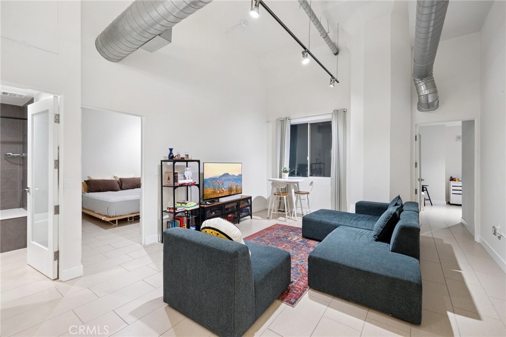 Welcome to the most affordably priced TWO BEDROOM unit in the area! Nestled in the heart of Downtown LA on the border of South Park and the Fashion District is 939 S. Broadway. This historic gem, adjacent to the famed Ace Hotel, was once the Western Costume Building, newly developed to seamlessly blend historic charm with contemporary living. Upon entering the unit, you will find a two bedroom, one bathroom, 849 square feet open layout with highceilings and modern industrial interiors. You will immediately notice the ample space and stainless steel appliances that come included in the kitchen. Additionally, the unit comes with in-unit stacked laundry, perfectly convenient for the building’s flexible living policy – including residential, rental, Airbnb, and live-work options. The building is equipped with 24-hour security and secured entrance access, as well as a rooftop retreat with a pool, spa, cabanas, and gym with a mesmerizing view of the city skyline. Explore the vibrant city scene just steps away, with dining, bars, and cultural landmarks at your doorstep.