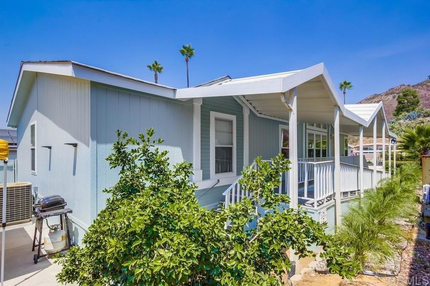 Welcome to Pepperwood Park, a desirable 55+ community in El Cajon known for its park-like setting with mature trees, rolling green meadows, and resort-style amenities. This spacious 3-bedroom, 2-bath home offers single-level living with a bright open floor plan and has been thoughtfully designed for accessibility with an ADA-compliant ramp, widened doorways, support rails, and a newly installed step-in therapeutic tub in the oversized primary suite. Additional highlights include new carpet in the main living area, fresh exterior paint, a beautifully landscaped front yard with automatic sprinklers, a tandem 2-car carport, private backyard with sitting area, and two storage sheds. Residents enjoy a heated pool and spa, exercise room, clubhouse with full kitchen, card room, library, pool tables, barbecue area, horseshoe pit, lush landscaping, and more! Conveniently located near shopping, dining, entertainment, and freeway access, this home combines comfort, accessibility, and community living in one of East County’s most welcoming 55+ neighborhoods.