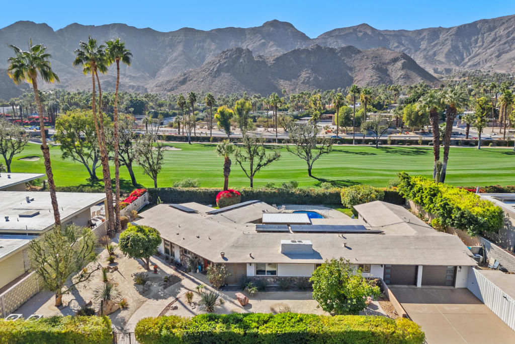 Fabulous Views and Provenance too! This upgraded mid-century home on 1/3 acre lot was one of the original Thunderbird Country Club homes located on the 3rd Fairway of this world-renowned golf course. This home was owned by both the famous musician and composer Hoagy Carmichael as well as owned by Sylvester Weaver, first President of NBC who started The Today Show (Father of actress Sigourney Weaver)...this was their winter home. It has wonderful views of the southern mountains from the living areas of the home, the back patio and pool. In 2019 a 500 sq ft addition was added. Features of this home include an open concept living area with architectural beamed ceilings, a huge double wide stone fireplace, a large island for cooking with a breakfast bar, hi-end stainless steel energy efficient appliances, an energy efficient foam roof, leased and owned solar with 25-year warranty and Tesla Powerwall Battery, new insulated garage doors, 3-zone AC units, new double paned windows, Covered patio with electric louvers and lighting, newly resurfaced back patio, mature fruit trees throughout property and water saving desert landscaping with privacy hedges front and back. The spacious master bedroom has lots of storage and there are His and Hers bathrooms with a marble Roman tub in Hers! The large pebble-tec pool has wonderful views of the mountains beyond. There is also a large extra storage area near the garage. Best of all - within walking distance of the Club House.