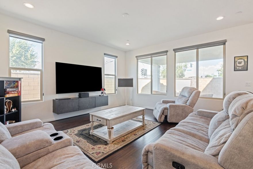 Welcome to this stunning residence set on a desirable corner lot with manicured landscaping and thoughtful design throughout. Go inside to a spacious open-concept great room that flows seamlessly into the beautifully upgraded kitchen, complete with quartz countertops, walk-in pantry, built-in range and hood, and a center island with bar seating—perfect for gatherings and entertaining. The main level features a junior suite bedroom with private bath, an additional office (6th bedroom option), and a convenient half bath. Upstairs, enjoy a versatile loft space, plus 4 generously sized bedrooms and 2 bathrooms, including the primary suite with dual-sink vanity, soaking tub, separate shower, and walk-in closet. An upstairs laundry room adds convenience. Outside there's a covered backyard patio with low-maintenance artificial turf while taking in scenic mountain views. The home also features a leased solar system for energy efficiency and a water softener hook up in the garage. Located in a well-maintained HOA community offering covered picnic areas with BBQs, manicured grounds, and sidewalks. A move-in-ready gem with space for everyone—don’t miss it!!