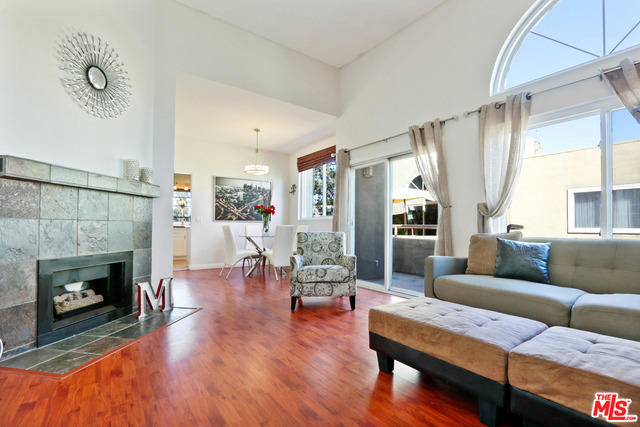 Walk into the large living with vaulted ceilings offering plenty of natural light throughout the unit. Enjoy the gas fireplace as well as the long balcony with views of the courtyard and trees. There's a spacious dining room and an updated kitchen with the washer and dryer. The master bedroom is large and also has vaulted ceilings with wide closets. The hallways include additional storage and there is one bathroom to share. The second bedroom is also very large with natural light and a sufficient amount of closet space. There is a large pool, a sun deck and a cabana for you to lounge on. 2 car tandem parking in gated garage.