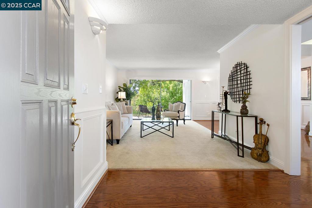 Welcome to a lovely Tamarisk condo in Rossmoor, the premier active-adult community in the Bay Area. This two bedroom, two bathroom property is one of the few homes in the community that has two dedicated parking spaces with both a detached garage and carport located just steps away from the front door. Another unique feature of this unit is the spacious ground floor patio that overlooks a serene park-like setting and views of the rolling Rossmoor hills. There is also a charming patio at the front entrance of the property, giving you multiple options for enjoying private outdoor living. Inside this two bedroom, two bathroom condo you'll discover many desirable features like the decorator wainscoting and sconces, gleaming hard-surface flooring, six-panel interior doors, and more. A new heating and air system was recently installed which means lower utility bills for you and greater energy efficiency. With just 5 steps to the front door the home is easily accessible but for those that can't manage stairs there is level-in entry available via a path to the side of the property leading to the private back patio. Lots of closets inside the home and a large loft in the garage provides an abundance of storage solutions. Move right in and start enjoying all Rossmoor has to offer!
