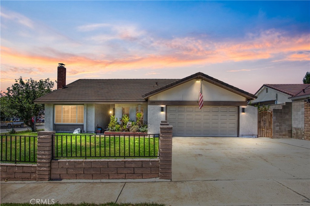 Love big views and lots of space? This comfy spot in Upland’s foothills might be just what you’re looking for. Perched on a large corner lot, the house is positioned to soak up those panoramic mountain views that never get old.
Inside you’ll find four spacious bedrooms. The primary suite has an upgraded walk-in shower and a sliding door that leads right to the lush back yard. The kitchen offers plenty of counter and cabinet space, a breakfast bar for quick bites, and a formal dining area for sit-down meals. A cozy fireplace anchors the living room for those quiet evenings at home.
Step outside to a backyard lined with fruit trees and a covered patio that’s perfect for hanging out or entertaining friends. There’s even a side-yard gate with room for an RV, plus a tool shed that stays put. With a two-car garage and extra parking on each side of the property, there’s no shortage of space.