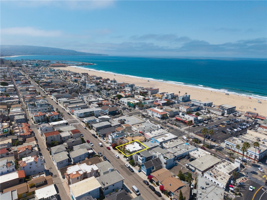 An exceptional opportunity awaits at 1111 Manhattan Ave, Hermosa Beach, where a stunning ocean-view residence is ready to be your new home. Step inside to an open floor plan flooded with natural light pouring in from oversized windows. The upper-level living room boasts commanding ocean and Hermosa Beach Pier views, and opens to an impressive entertaining deck. Culinary enthusiasts will delight in the spacious kitchen, which is equipped with expansive counters, ample cabinetry, and top-of-the-line appliances. A versatile fifth bedroom provides the perfect space for a home office or creative studio. Additionally, a lower-level walk-out bonus room adds versatility and fun to the layout. Inside, features such as built-in cabinetry, ceiling fans, laundry room, and recessed lighting enhance the home’s character and charm. This property is situated on a generous 40-foot-wide, 4,010-square-foot lot. The enclosed back patio provides a private and tranquil retreat, complete with a built-in gas fire pit, perfect for entertaining or simply enjoying the outdoors. An outdoor shower adds a convenient touch after a day at the beach. With underground utility lines ensuring uninterrupted views, it's easy to see why this sought-after neighborhood is so beloved. This extraordinary property offers the perfect blend of comfort, style, and an unbeatable location, embodying the best of Hermosa Beach living.