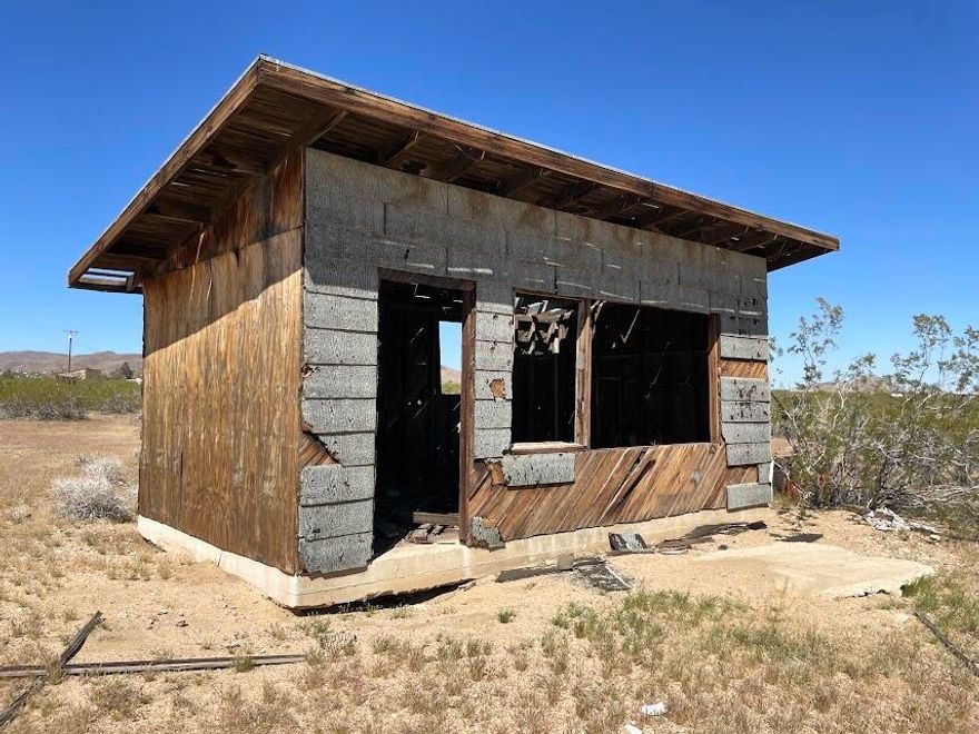 Mid Century flat-roof Homestead cabin set on 5 acres with views, utilities, & road access. Private setting just 2 streets away from hundreds of government open space land for hiking, dog walking & horseback riding. Zoned RL-5 which may allow for limited camping, 2 homes, guest homes & jr guest homes. Ideal for creating your dream compound. Many new designer homes in the area. Hot vacation destination with close proximity to the Integratron, Giant Rock, Johnson Valley & endless wilderness trails & canyons. Landers is seeing more celebrities, artists & musicians calling the area home than ever before. Inspiring vistas of the towering signature mountain that dominates the landscape. Views of the Bighorn Mtns, Landers, Mtn, & the Bullion Mtns that often glow red in the last light of the day. Shimmering city lights at night. Enjoy a peaceful campfire with friends under the vast milky way. About 1 hour to Big Bear & Palm Springs. 25 minutes to Joshua Tree National Monument where about 3 million tourists visit annually. 2.5 hours to LA. Short trip to organic restaurants, cafes, bars & shopping. The world famous music venue Pappy & Harriets is nearby in Pioneertown. For all questions & uses with Homestead cabins, buyers must contact the county. For all questions on utilities buyers must contact the utilities agencies. Address is not an assigned address & is for marketing purposes only. GPS: 34.282417, -116.425980 APN: 0629-322-16 Don't Wait! - Call Now!
