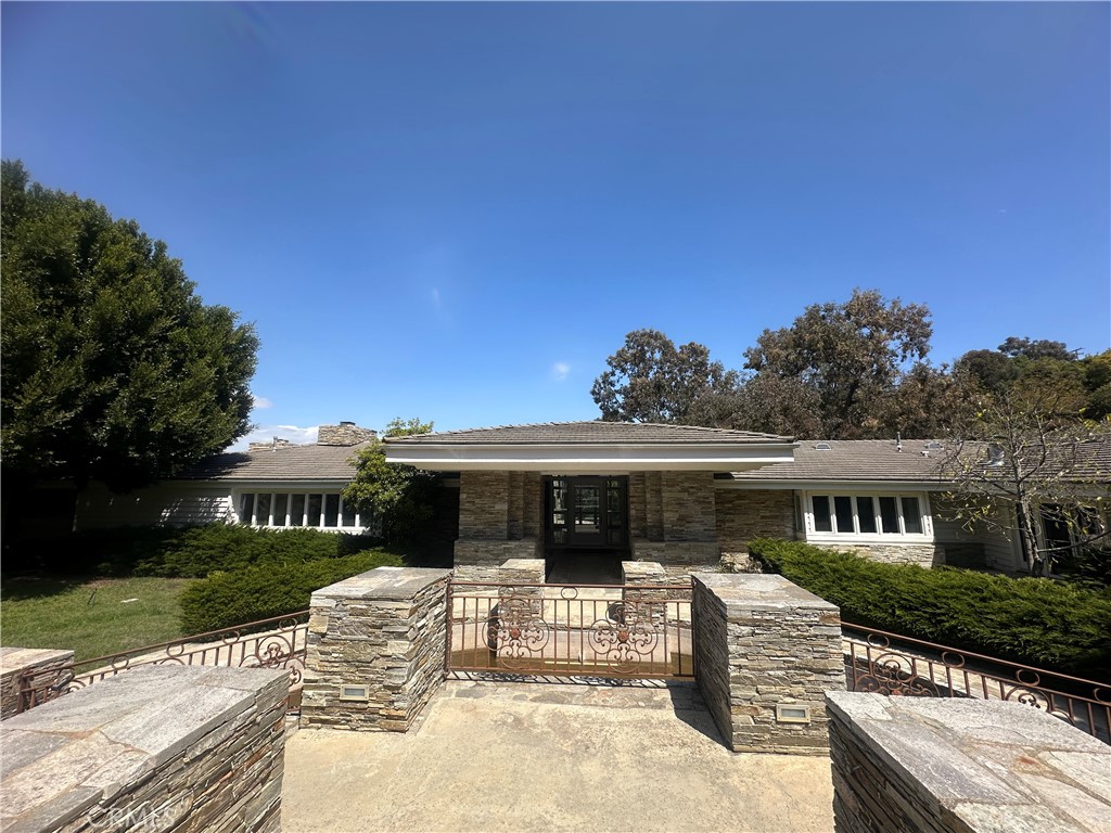 This beautiful single family residence is situated in a highly secured 24 hour guard gated city. This Contemporary classic ranch style with gorgeous views and large windows throughout. This Single story 5 bedrooms/6 bath estate sits on approx 3 acres of impeccable landscaping all behind a long and private gated driveway. The backyard features a cascading waterfall from the house to the negative edge pool and in-ground spa sits next to a large high vaulted ceilings and gourmet chef's kitchen with separate formal dining area. The master suite features its own fireplace with a large walk-in closet, private mahogany wood adorned study w/fireplace, and a spa-quality master bath.