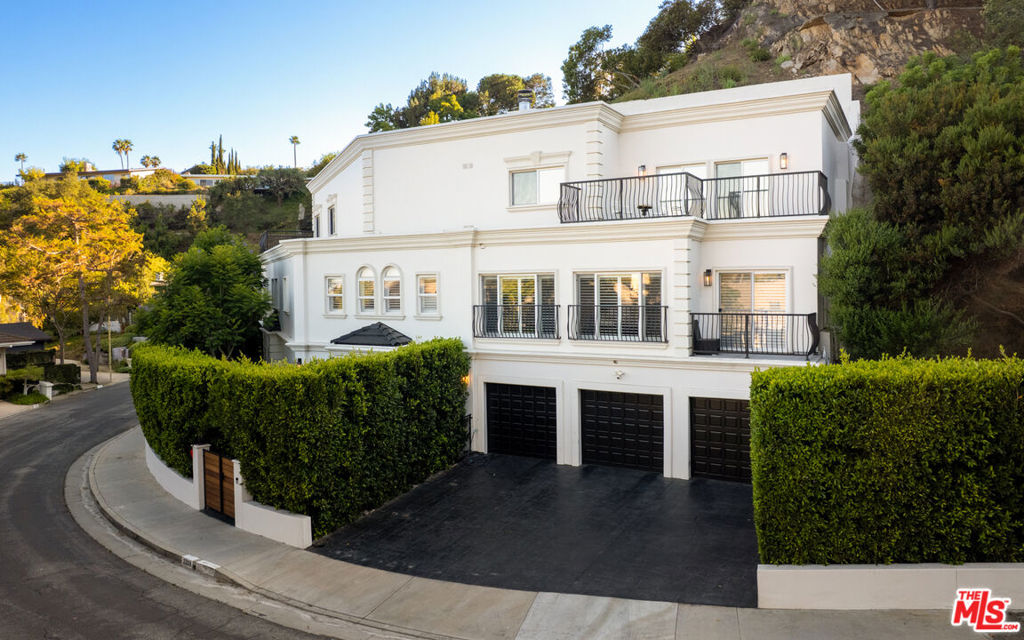 Wonderfully expansive Mediterranean-style home uniquely sited at an east-west curve on Banyan Drive in Mandeville Canyon. Three stories, with a double-height entry, 2209 Banyan boasts vast entertainment spaces, many with grand ebony-colored fireplaces, the formal living room is host to a custom-built marble-topped wet bar, elegant coving, wainscoting, and banks of modern bespoke shuttered windows. The family room with tray ceiling leads to a beautifully appointed chef's kitchen with 60" dual oven range, wine cooler, generous pull-up island, and access to outside. This bright 5-bedroom, 5-bathroom home has undergone a comprehensive list of renovations and upgrades with unmatched quality throughout; no corner of this stand-out property or grounds has been left untouched. Many of the bedrooms feature fireplaces, large closets, detailed ceilings, and walk-out balconies, some with city or mountain views. En-suite features include marble floors and vanities, as well as a combination of stand-alone bathtubs and walk-in showers. Privacy abounds in the unique tiered gardens, with vignettes that house a hot tub, red-light sauna, sheltered seating, and an outstanding pavilion over an outdoor kitchen with counter-height dining for eight and wall-mounted TV, perfect for viewing parties and sports events. Other standout features include an elevatorrecently serviced and wallpaperedan Lutron Smart lighting system (app-controlled), electronic blinds in the primary suite, and a three-car garage with Tesla charging station. This home is close to the Westridge Trailhead, a paradise for hikers and bikers alike, and is situated in a quiet, notable neighborhood of Brentwood