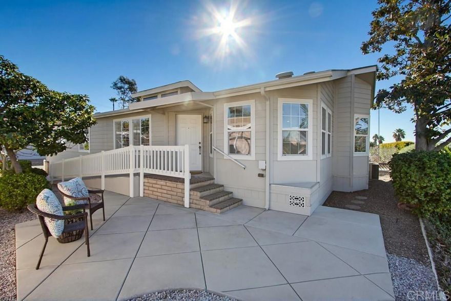 FABULOUS 2BD + BONUS ROOM! Welcome to this wonderful home featuring 180-degree west-facing views located in the gated 55+ community of Rancho Escondido, a land-owned community with no space rent. The home offers a comfortable, well-laid-out interior with an open island kitchen featuring skylights that bring in natural light, along with custom pull-out cabinetry and generous counter space. The layout feels open and functional, making everyday living easy and comfortable. A den with double doors provides flexible space that can be used as a home office, hobby room, or additional sitting area. The utility room includes a deep sink and a stainless washer and dryer. Ramp access to the front door adds convenience and accessibility. The primary bedroom features dual sinks and double closets, while both bedrooms include walk-in closets, offering ample storage throughout the home. Outdoor areas include two patios where you can relax and enjoy the west-facing views and natural breeze, along with a storage shed for additional convenience. Rancho Escondido is a well-maintained, gated 55+ community offering two clubhouses, pools and spa, fitness room, billiards, library, greenbelts, dog park, and a variety of community activities. RV storage is available on site, subject to availability. Conveniently located near the I-15 freeway, golf courses, parks and trails, lakes, shopping, and dining. Primary resident must be 55+, with a secondary resident 45+.