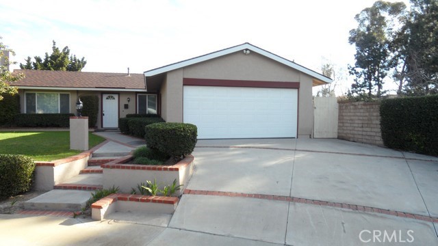 Updated, Single-Story, 3 bedroom, 2 bathroom home in cul-de-sac with beautiful landscaping in Yorba Linda High School district. Modern decor, wood like vinyl flooring, central A/C, and carpet in all bedrooms. Kitchen features quartz countertops with stainless steel sink, canned LED lighting; all stainless steel appliances include gas cooking, built-in microwave oven, dishwasher, and eating area. Sliding glass door leads to backyard patio. Hall bathroom features vanity with granite countertop and shower/tub combo with beautiful tiling to ceiling. Master bedroom with attached private bathroom includes vanity with granite countertop, shower stall with beautiful tiling and natural rock floor, mirrored closet doors. Large living room with cozy fireplace and built-in bookshelves. Attached two car garage with remote. Washer/dryer hookups located inside the garage.