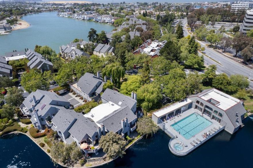 Experience resort-like living at 919 Shoreline Drive, a cheerful ground-floor, corner unit condominium in San Mateo's coveted Harbortown community. This two-bedroom, two-bath home offers seamless indoor-outdoor flow with two private patios and peekaboo views to the pool and lagoon. Step inside to find an open layout enhanced by high ceilings, crown molding, and recessed lighting and anchored by rich hardwood flooring. The kitchen is equipped with Bosch and Sub-Zero appliances, sleek cabinetry, and abundant storage. The open living and dining area is framed by sliding glass doors leading to two private patios - perfect for relaxing or entertaining. The primary suite features direct patio access and a spa-inspired bathroom with a walk-in shower and stone-topped vanity. The secondary bedroom includes custom closets and easy access to the full hallway bath, complete with updated finishes and linen storage. Enjoy community amenities including swimming pools, tennis courts, a community garden, and lagoon-side pedestrian paths. Located near Bridgepointe Shopping Center, Mariners Island Park, and the Bay Trail, with quick access to CA-92, US-101, and SFO, this home delivers comfort, convenience, and natural beauty in equal measure. Come in...and welcome home!