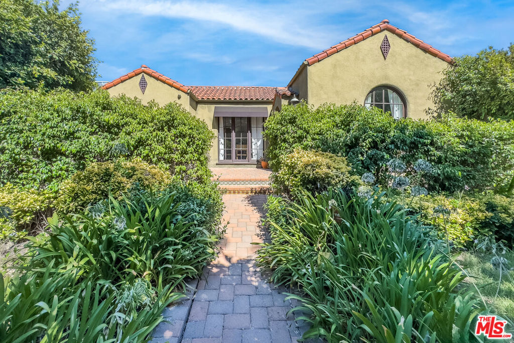 Private, hedged, and gated, this enchanting Spanish home is the lease everyone has been looking for. As soon as you enter through the charming courtyard, you feel like you're leaving the city behind. The romantic living room looks out to a fountain and features a fireplace, great windows and light, and a dining room overlooks the lushly landscaped courtyard. The kitchen has stainless steel appliances, an adorable eat-in breakfast nook with corner cabinets, and access to a laundry room. The main house offers three bedrooms, all nicely scaled. The primary bedroom has two walk-in closets and a large bath and opens to a nice grassy backyard and veranda for al fresco dining. The garage has been converted to a studio with a kitchen and bath. The house is also powered by solar, so there is a huge savings on electricity. A short distance away from restaurants, high-end boutiques on Melrose and Beverly Blvd, Erewhon, The Grove and Farmers Market, this is your perfect LA lease. Available furnished or partially-furnished so you can move right in!