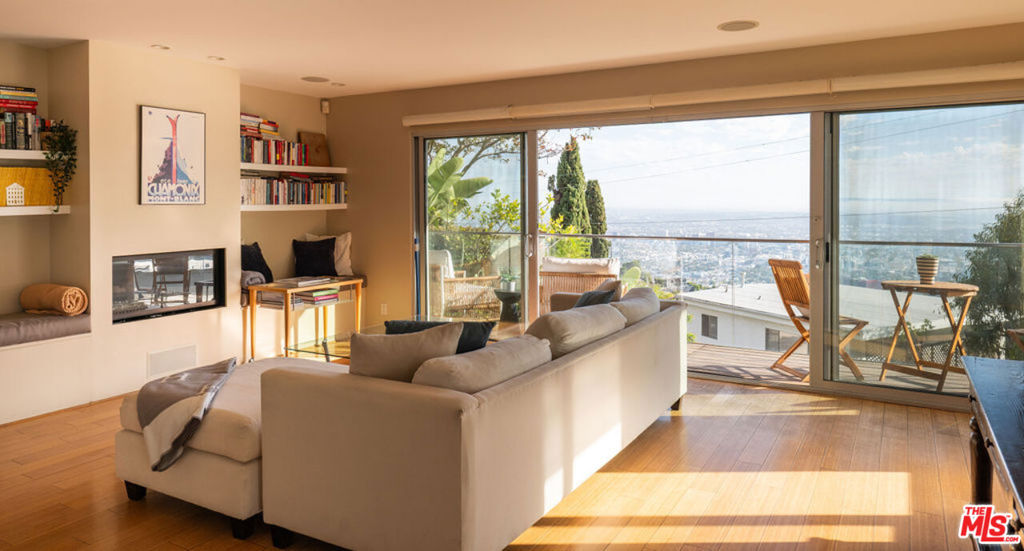 Perched high above the city on upper Sunset Plaza, this three-bedroom, three-bath architectural gem captures sweeping 180-degree views from the Los Angeles skyline to the Pacific Ocean and beyond. Designed for seamless indoor-outdoor living, walls of glass open to expansive terraces and a spectacular 900-square-foot rooftop deck ideal for entertaining beneath the stars. Inside, sleek contemporary design meets warm sophistication, with thoughtful details and abundant natural light throughout. Gated and private yet moments from Sunset Boulevard, this residence embodies the essence of refined and effortless Los Angeles living.