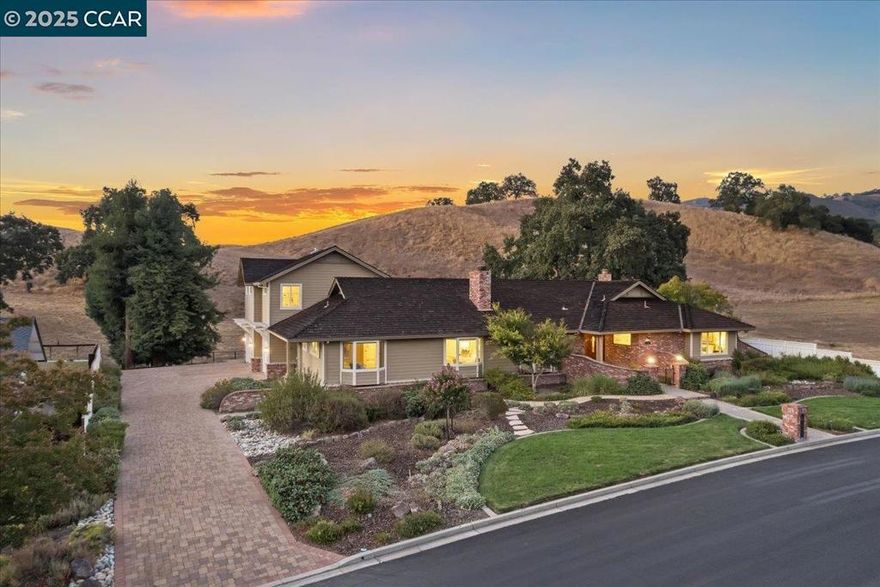 Unparalleled luxury and privacy in the highly sought-after and gated Hidden Oaks.  This stunning estate offers 5-bedrooms, 3-bathrooms spanning more than 4,000 square feet, with 3,200 square feet on a single level for seamless living. The gourmet white kitchen, featuring a large island and stainless steel appliances, is perfect for culinary enthusiasts. Host elegant gatherings in the formal dining room or relax in the sophisticated living room by the fireplace, one of three on the property. Hardwood flooring and meticulous millwork graces the living areas, while high-end carpeting adds comfort to the bedrooms. The primary suite is a serene retreat with a cozy sitting area, spacious walk-in closet, and a spa-like bathroom with multiple shower heads. Two additional main-floor bedrooms share a bathroom with a tub and shower, and a dedicated office supports remote work or study. Upstairs, a versatile loft, two bedrooms, and a full bathroom offer flexibility, with potential to be used as an ADU.  Set on a half-acre lot with no rear and only one side neighbor, the property is surrounded by open space, ensuring seclusion and stunning views. Don't miss this rare opportunity to own a slice of paradise in one of Danville's most desirable enclaves!