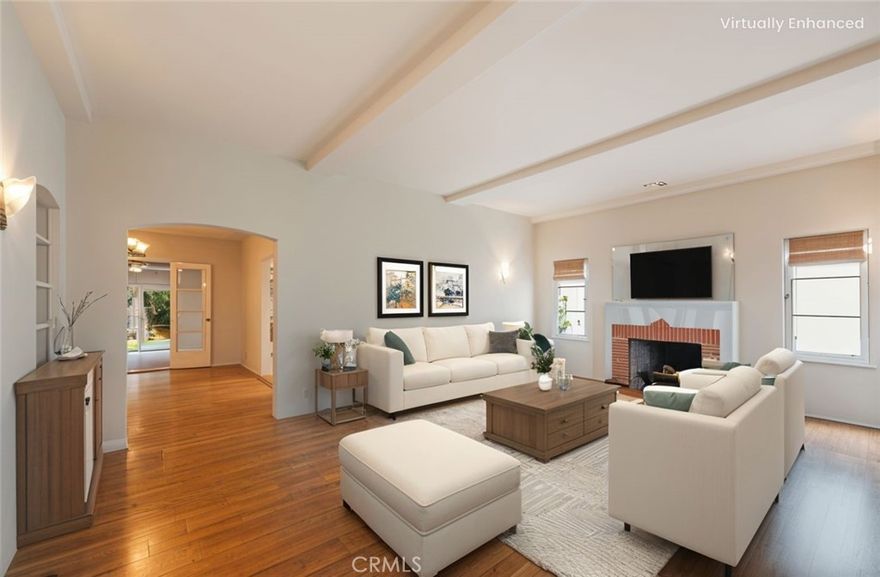 This timeless Spanish home blends classic charm with modern comfort in the heart of Glendale. Situated on a tranquil, tree-lined street in Northwest Glendale, the 3-bedroom, 2-bathroom residence showcases authentic Spanish architecture enhanced by thoughtful updates, creating a warm and convenient single-story retreat. A spacious front loggia, accented with period-inspired columns, leads to the front door and offers a welcoming view of the landscaped front yard. Step inside and be welcomed by the gorgeous art deco fireplace and the warmth of peg-and-groove hardwood flooring that flows throughout the home. The updated kitchen features modern appliances, ample cabinetry, and a convenient laundry area with washer and dryer included. French doors open to a beautifully landscaped backyard, creating a seamless indoor-outdoor living experience. The main bathroom includes restored vintage bathroom tile, fresh interior paint, and recent exterior paint, highlight the care and pride of ownership. Comfort is ensured year-round with a newer HVAC, central A/C, tankless water heater, and updated electrical. The backyard is designed for both relaxation and entertaining, featuring a custom outdoor BBQ kitchen with sink and fridge, along with mature landscaping that creates a private, peaceful setting. A detached garage provides parking for two and offers ADU potential for additional living or income opportunities. Perfectly situated between Griffith Park and the Verdugo hills of Angela's Crest Forest while still near the Disney and DreamWorks campuses, Kenneth Village, Montrose and only minutes from the Glendale Galleria, Americana at Brand, and the Glendale Narrows Riverwalk running trail. With its classic Spanish architecture, versatile floor plan, and prime Glendale setting, 913 Norton Avenue offers not only a residence but a lifestyle to be cherished.