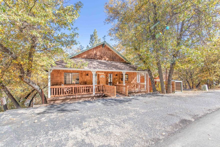 In quiet upper Moonridge, this 3 bedroom, 2 bath home provides a cozy cabin feel with lots of creature comforts! Offered fully furnished, this home is ready for you to just bring your toothbrush! Boasting a main-floor bedroom with deck access, main floor bath, & level entry, this open-floorplan home has woodsy finishes, such as the shaker-style shingle exterior siding, vaulted tongue-in-groove ceilings & accent wall, river rock fireplace with firewood storage nook & adorable raw-edge mantle with bear carving, honey-finish cabinets & wood floors in the bright & airy kitchen, plus more T&G & honey cabinets in the master bedroom & laundry room. Stainless steel refrigerator, stove, dishwasher & microwave bring a modern touch. Skylights & windows abound in this well-lit cabin! Sit or soak for hours enjoying the oaks, pines & peekaboo mountain views from the spacious rear deck with hot tub. Level parking on the sunny side of the street helps with quick snow melt. Cabin décor & proximity to the slopes (1.8 miles) lake (4 miles) & Village (4.2 miles) has made this a successful vacation rental. It could also be a fantastic getaway or permanent residence. This is a must-see!