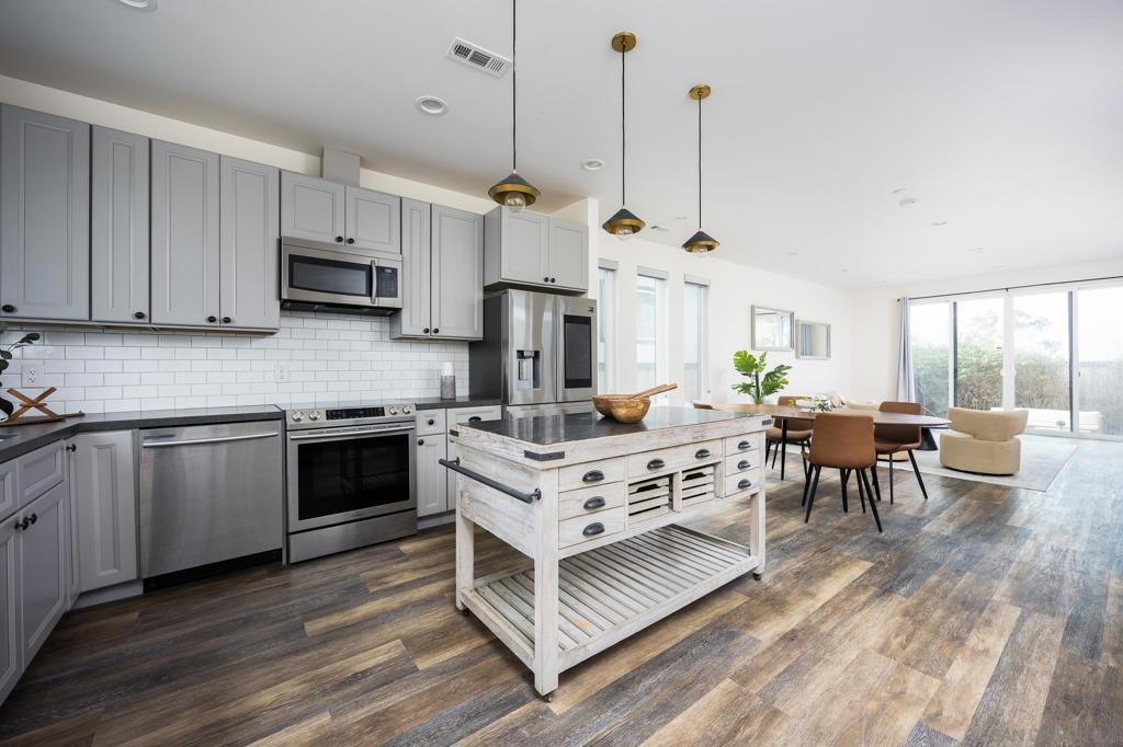 Introducing a stunning new construction home in the heart of South Park—offering modern design, premium upgrades, paid solar and versatile living spaces, all with no HOA or Mello-Roos. This thoughtfully designed residence features two spacious primary suites upstairs, each with its own private bathroom, walk-in closet, and private deck—perfect for added privacy or multigenerational living. On the main level, a full bedroom and bathroom provide flexible options for guests or a home office. The bright, open-concept layout is anchored by a chef’s kitchen equipped with a custom island, leathered quartz countertops, subway tile backsplash, and high-end Samsung smart appliances. Just off the kitchen and living room, a central private patio offers the perfect space for outdoor dining or quiet relaxation. Additional highlights include soaring vaulted ceilings, a formal entry, smart central AC and heat, Nest doorbell, upgraded dual-pane windows, custom window screens, and a stylish wet bar complete with wine and beer cooler. The home is completely gated, features water-efficient landscaping, and includes four off-street parking spaces. Fire sprinklers and energy-efficient features offer peace of mind and modern convenience. Located within walking distance to everything South Park and North Park have to offer, and surrounded by future development including two additional new homes and a 75-townhome community planned nearby—this is your chance to be part of the most exciting new pocket of South Park.