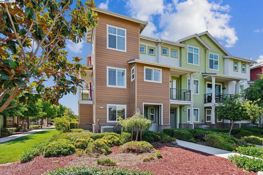 Modern East Facing Townhome-Style Condo Corner Unit with Luxury Finished & Prime Location. Overlooking the beautiful lush open green spaces with basketball court, playground, and community amenities! Ground-floor bedroom suite ideal for guests or a private office. Enjoy upscale touches throughout, including rich hardwood flooring, recessed lights, elegant crown molding, plantation shutters, built in surround sound system and water softener. Open-concept second level is the heart of the home featuring a chef's kitchen with granite countertops, center island, stainless steel appliances including refrigerator and built-in 5-burner gas range & walk-in pantry w/glass door. Expansive balcony with upgraded flooring perfect for morning coffee or evening relaxation. Upstairs the luxurious primary suite and vaulted-ceiling secondary bedroom each feature walk-in closets and en-suite bathrooms, offering privacy and comfort for all. Ample storage solutions throughout the home and the tandem 2 car garage. HOA dues include pool, spa, clubhouse & fitness gym. Easy Access to 580 and 84, next to Cayetano Park & Hiking Trails, close to Costco, San Francisco Premium Outlets, Restaurants, Shopping, Las Positas College & More!