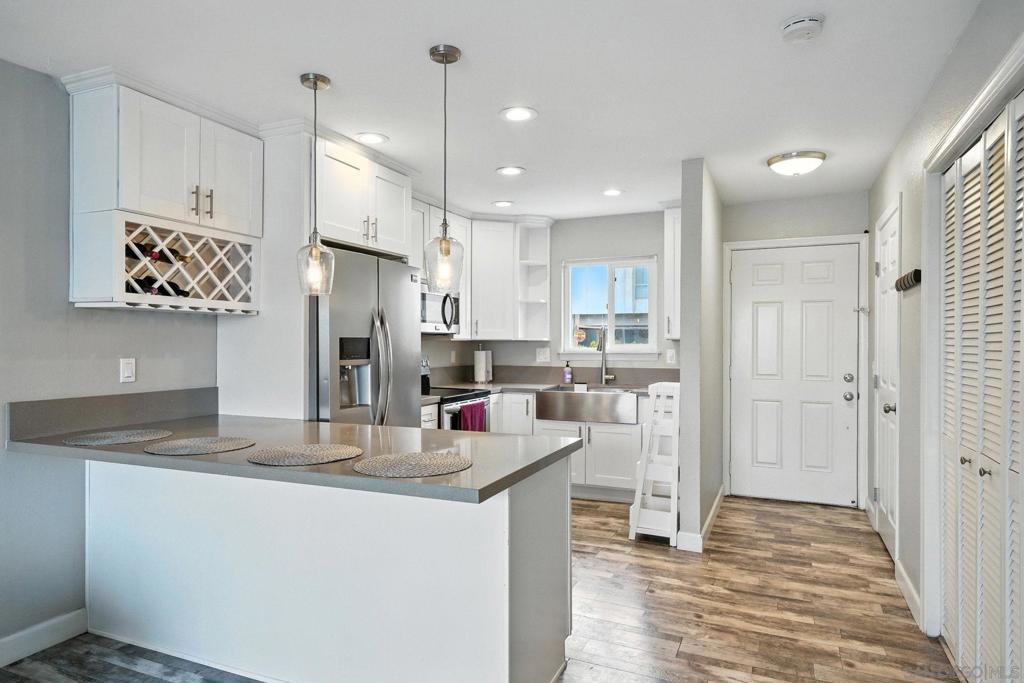 Great Opportunity in City Heights! Enjoy living in the heart of San Diego in this townhome with designer finishes and ideal conveniences! Home features some city views and breezes, hard surface professional grade flooring throughout, quartz counters, stainless steel appliances and farmhouse sink. Full sized washer and dryer located in the laundry closet. Ceiling fan, pendant lights and white cabinetry on the first floor with under the stair storage and a half bath. Upstairs you will find two bedrooms with large closets and a full bath. Enjoy BBQS in the fully fenced front patio with two planter areas ready for flowers? Pet relief area? Vegetable garden? Oversized, gated two car garage w/o direct access located below. Not every unit of the 7 in this complex has a garage! Near all including, freeways, restaurants, shopping, transit, park and recreation center. MUST SEE
